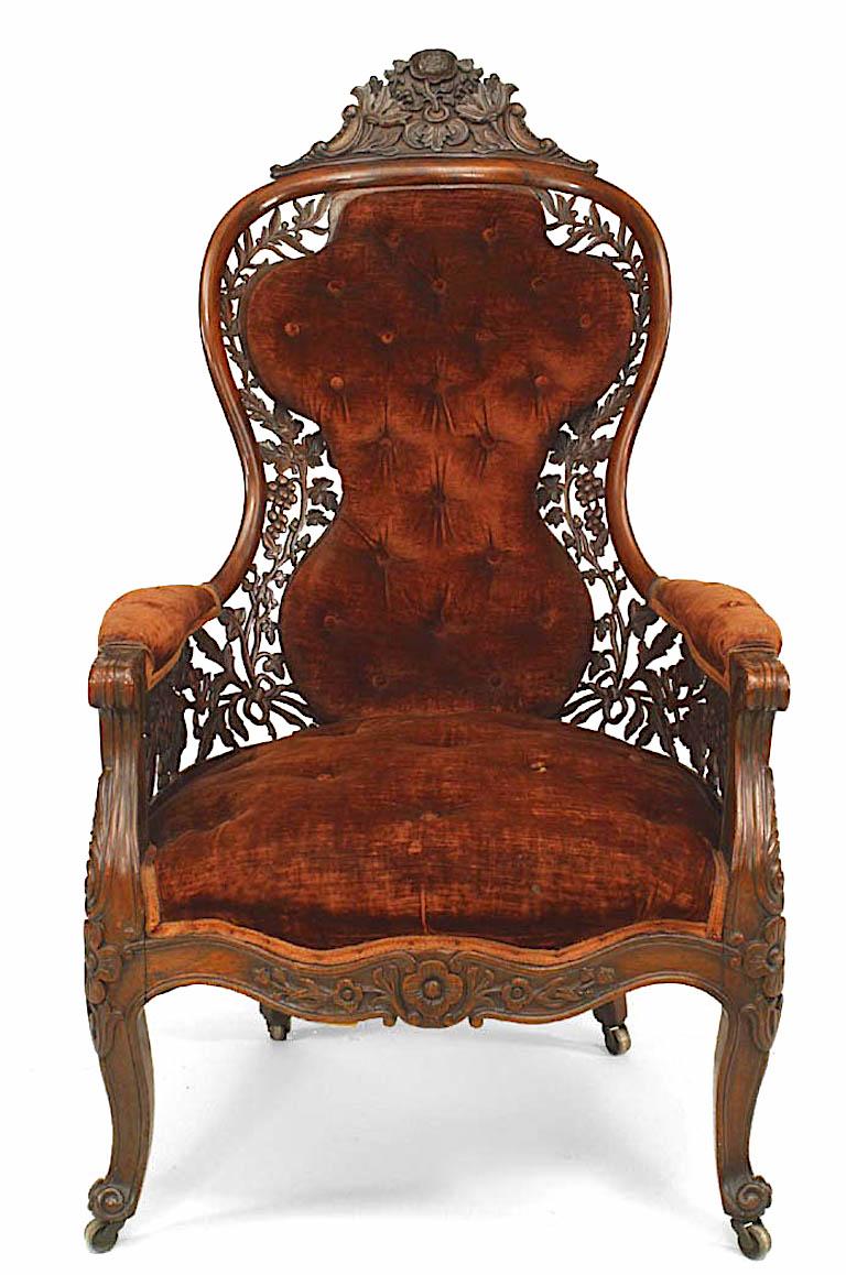 American Victorian carved rosewood bergere arm chair with filigree back and sides and rust velvet upholstery (Attributed to JOHN HENRY BELTER)
