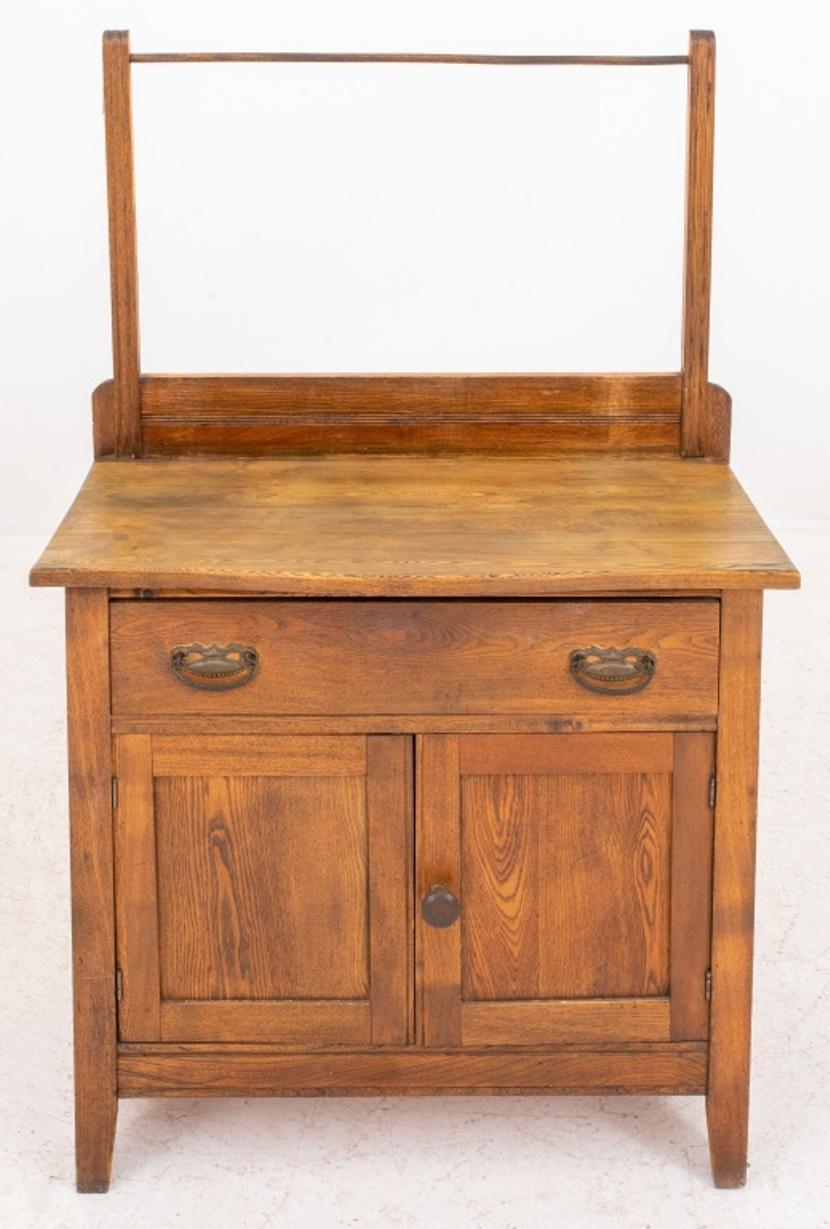 American Victorian country oak wash stand, shaped rectangular top with towel rack above, with trwo short drawers and two cabinet doors. 28.5