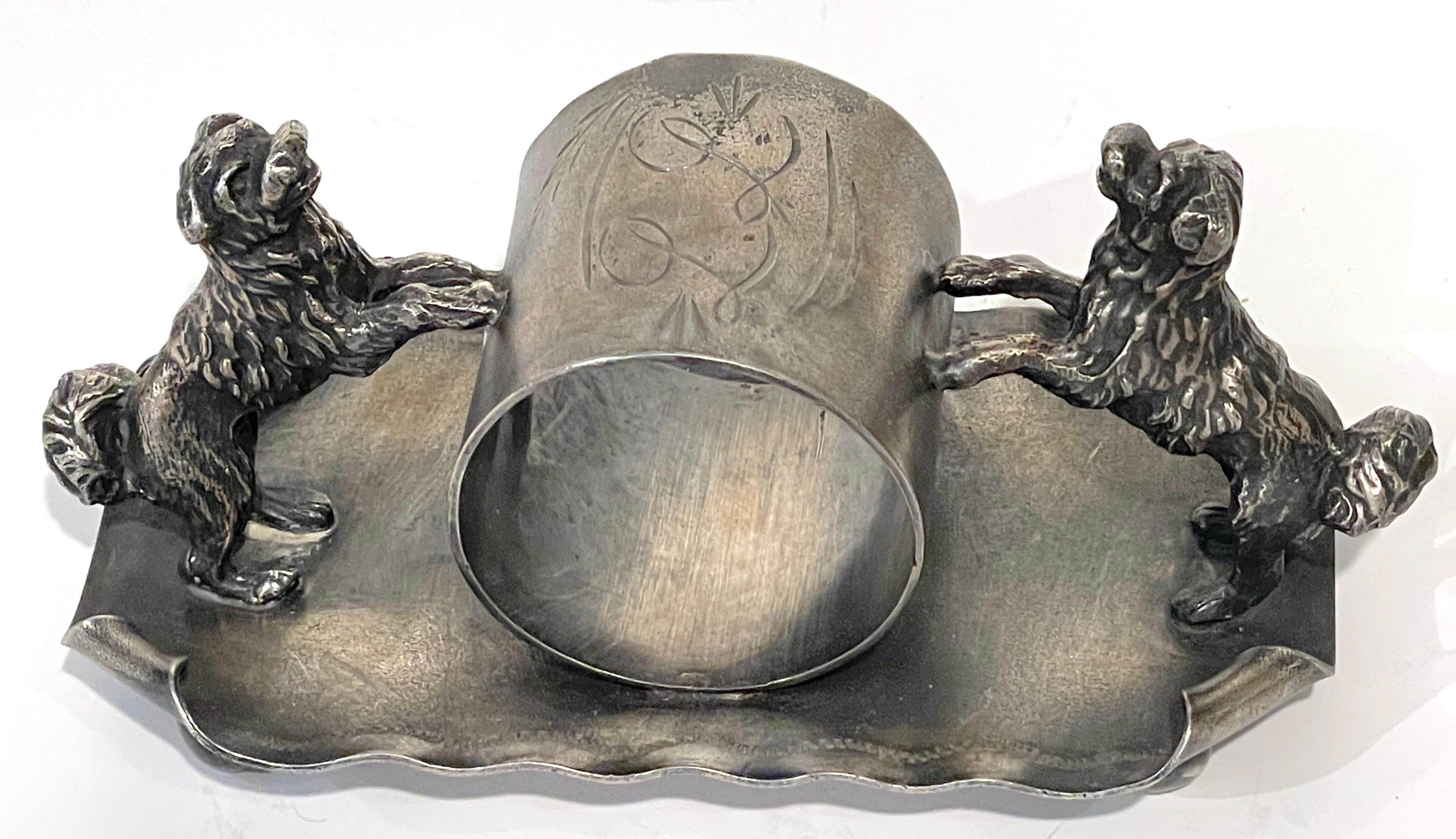 American Victorian 'Double Dog' Silverplated Figural Napkin Ring, Circa 1890 

An impressive American Victorian 'Double Dog' silverplated figural napkin ring circa 1890. This substantial piece, measuring 5.5 inches wide, 2.5 inches deep, and 2.5