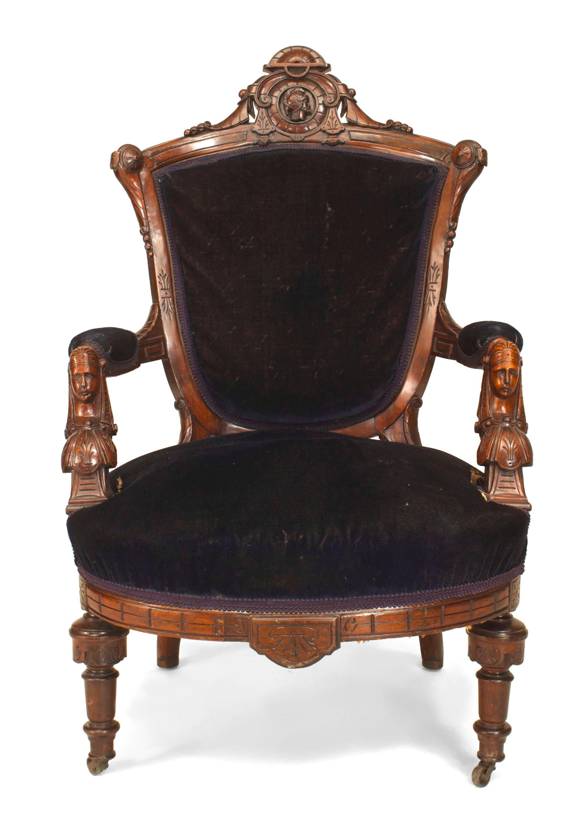 American Victorian Eastlake-style (Renaissance Revival) walnut arm chair with carved heads and blue velvet upholstery. (Attributed to JOHN JELLIFF & CO)

