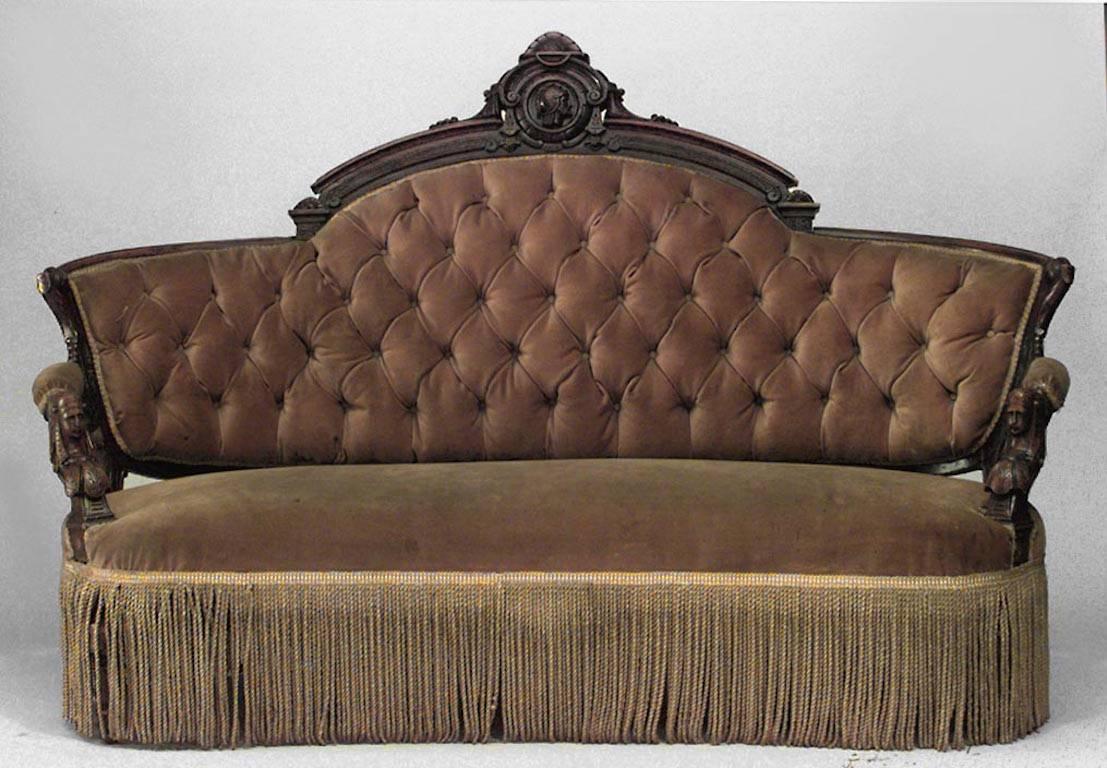 American Victorian Eastlake style (Renaissance Revival) walnut settee with carved heads and gold upholstery with fringe (att: JOHN JELLIFF & CO)
