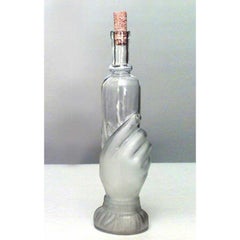 American Victorian glass decanter of hand holding small bottle