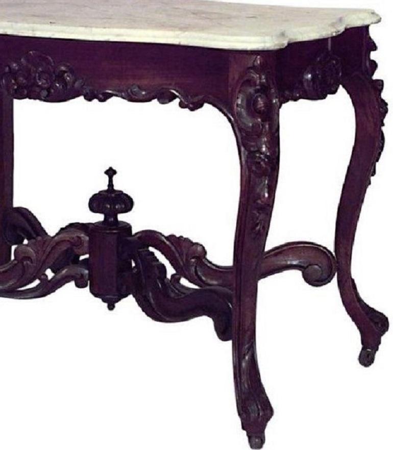 American Victorian rosewood rectangular serpentine shaped center table with stretcher and white marble top (attributed to JOHN HENRY BELTER).
