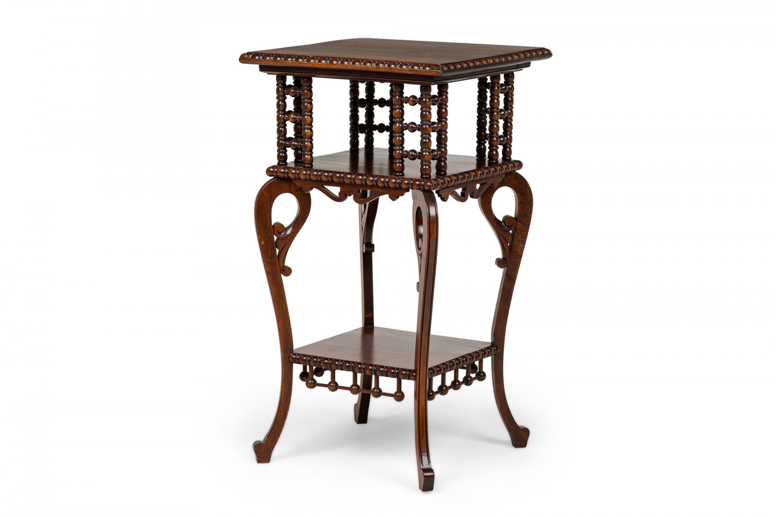 American Victorian mahogany square side table with 2 stretcher shelves, splayed scroll legs, turned ball supports and decorative ornamentation.