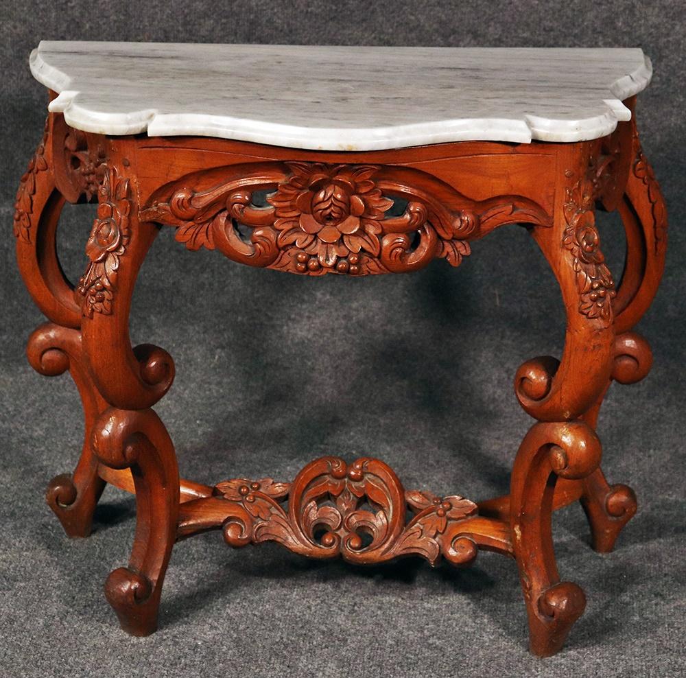 American Victorian carved walnut marble-top console table.
