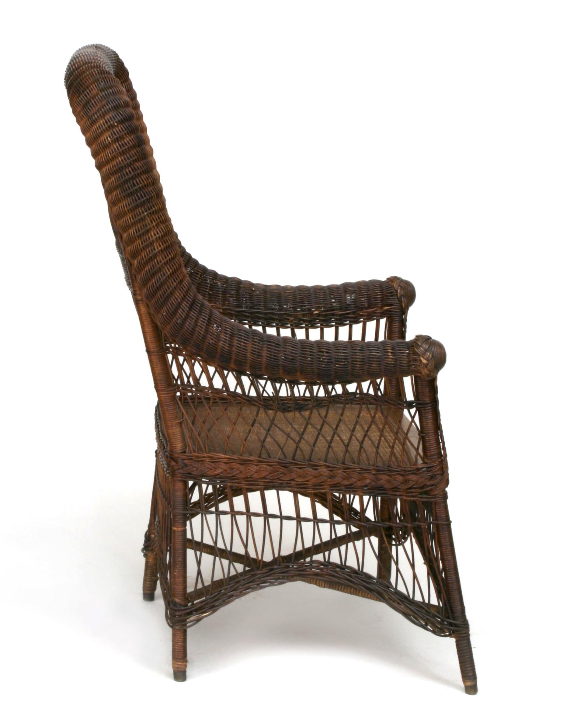American Victorian/Mission dark stained wicker arm chair with a high rounded back and arch design under seat. (att: HAYWOOD WAKEFIELD)
