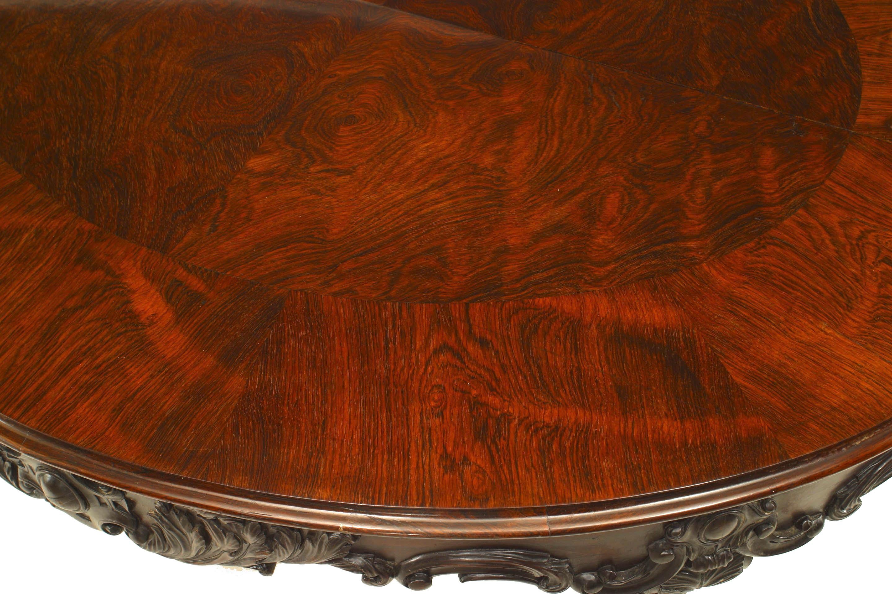 American Victorian rosewood oval center table with carved stretcher centered with urn (attributed to ALEXANDER ROUX).
