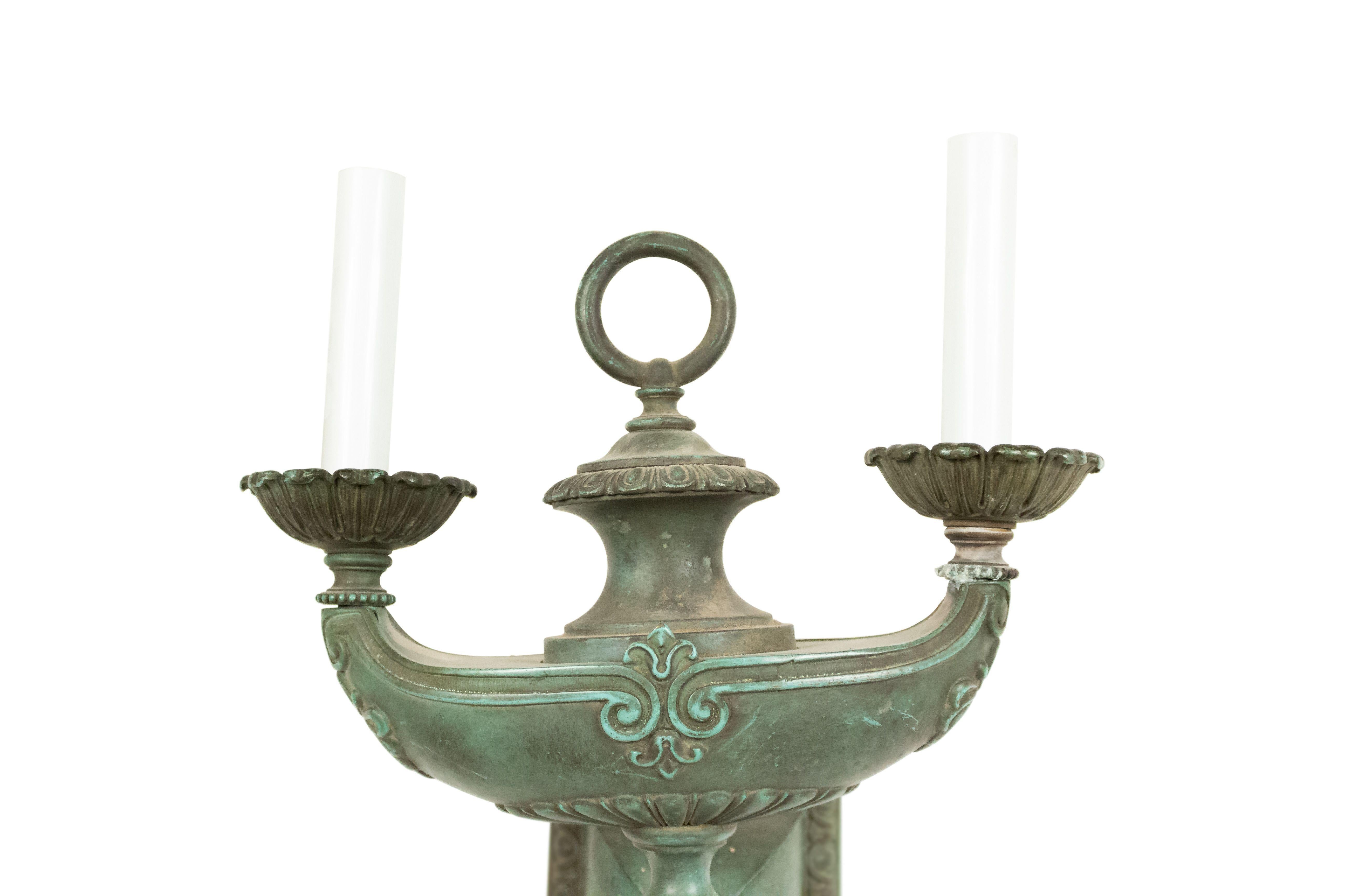 American Victorian bronze (with green patina) wall sconce with a two-light Aladdin lamp design, finial bottom, and ring top.
 