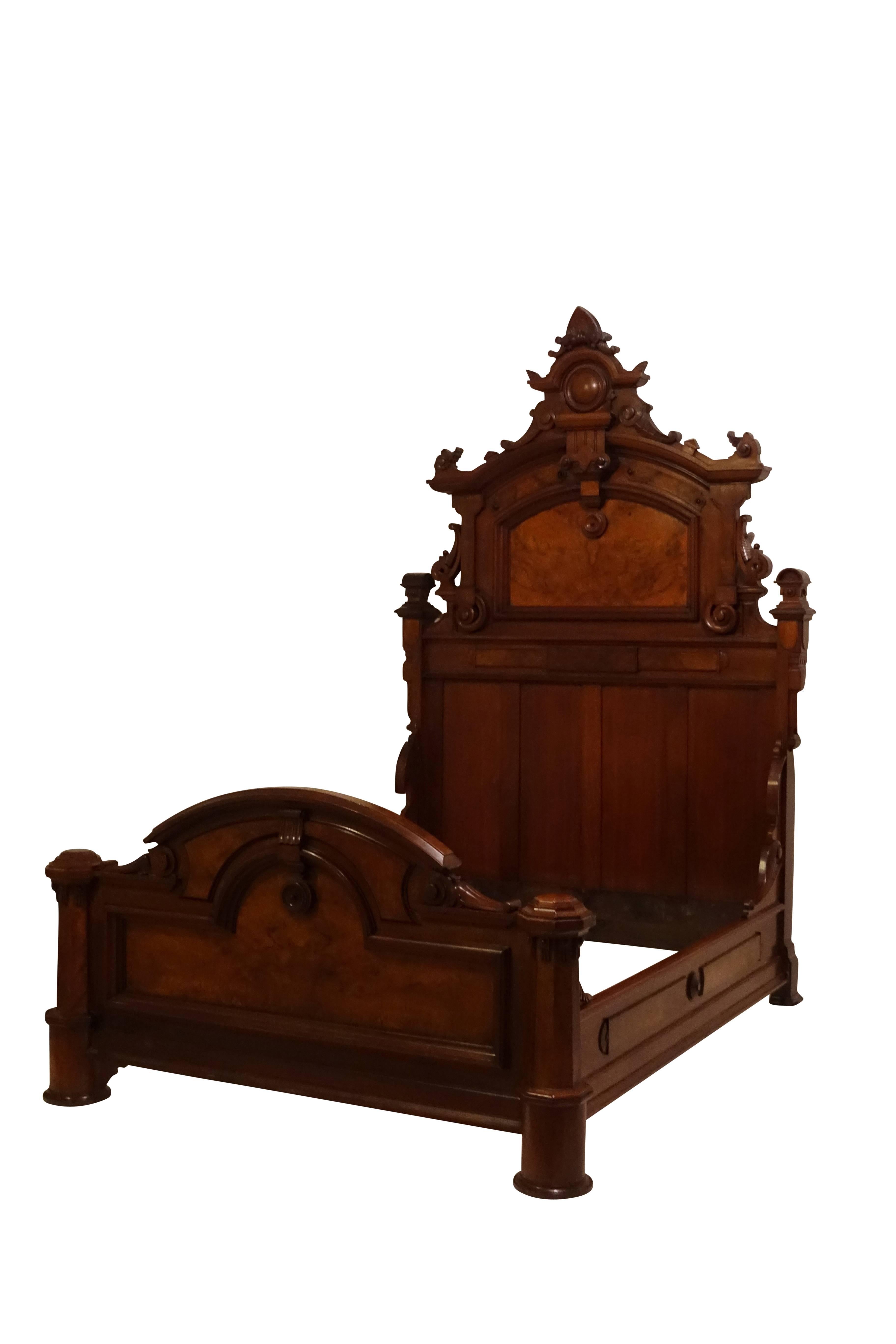 Victorian Renaissance standard full size bed. Architecturally beautiful, heavily carved walnut with panels of burled walnut in excellent original condition with original finish, American, 19th century.