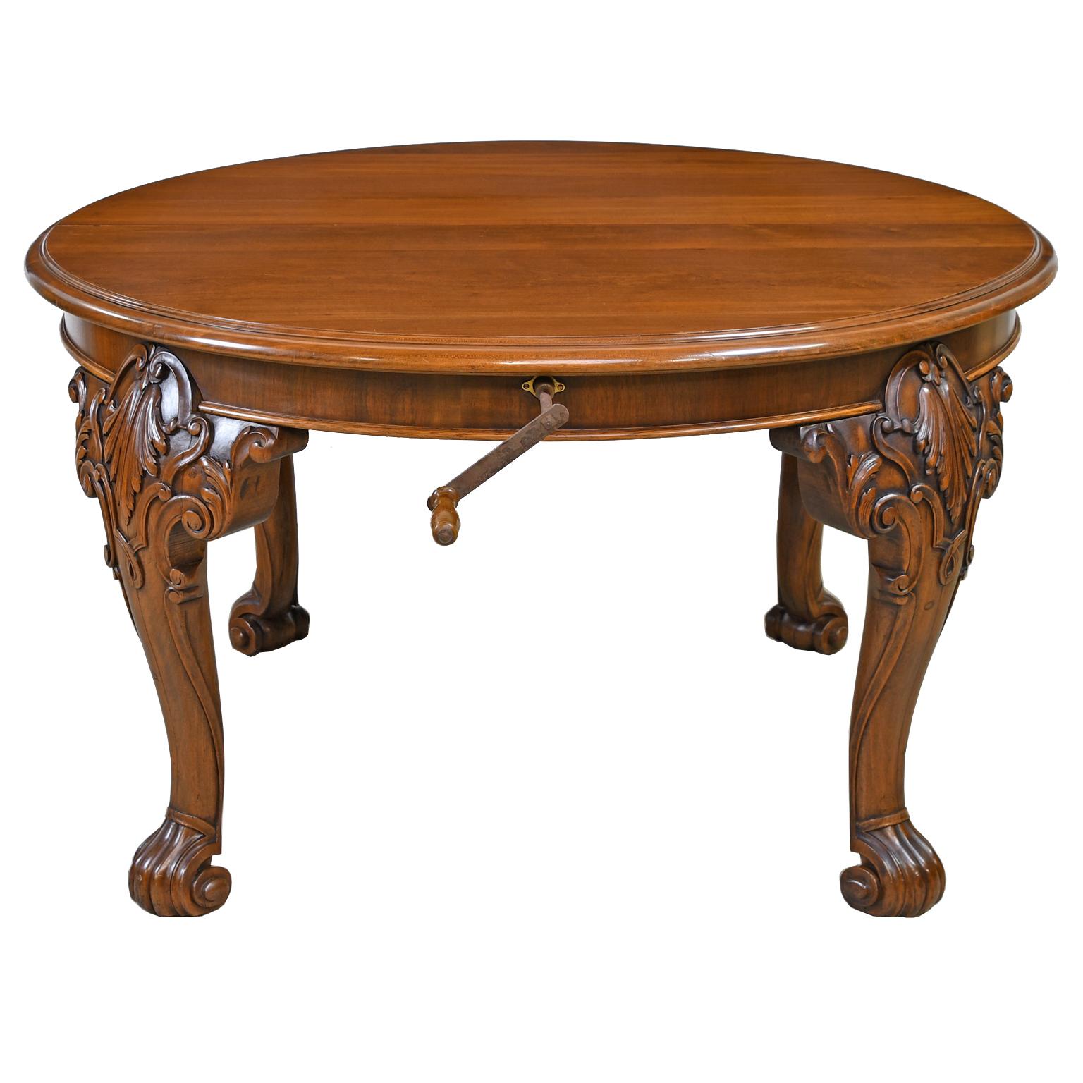 A very beautiful Victorian extension dining table in solid walnut with racetrack form on cabriole legs with carved cartouches and acanthus foliage on knees, and resting on scroll feet. Features a 54