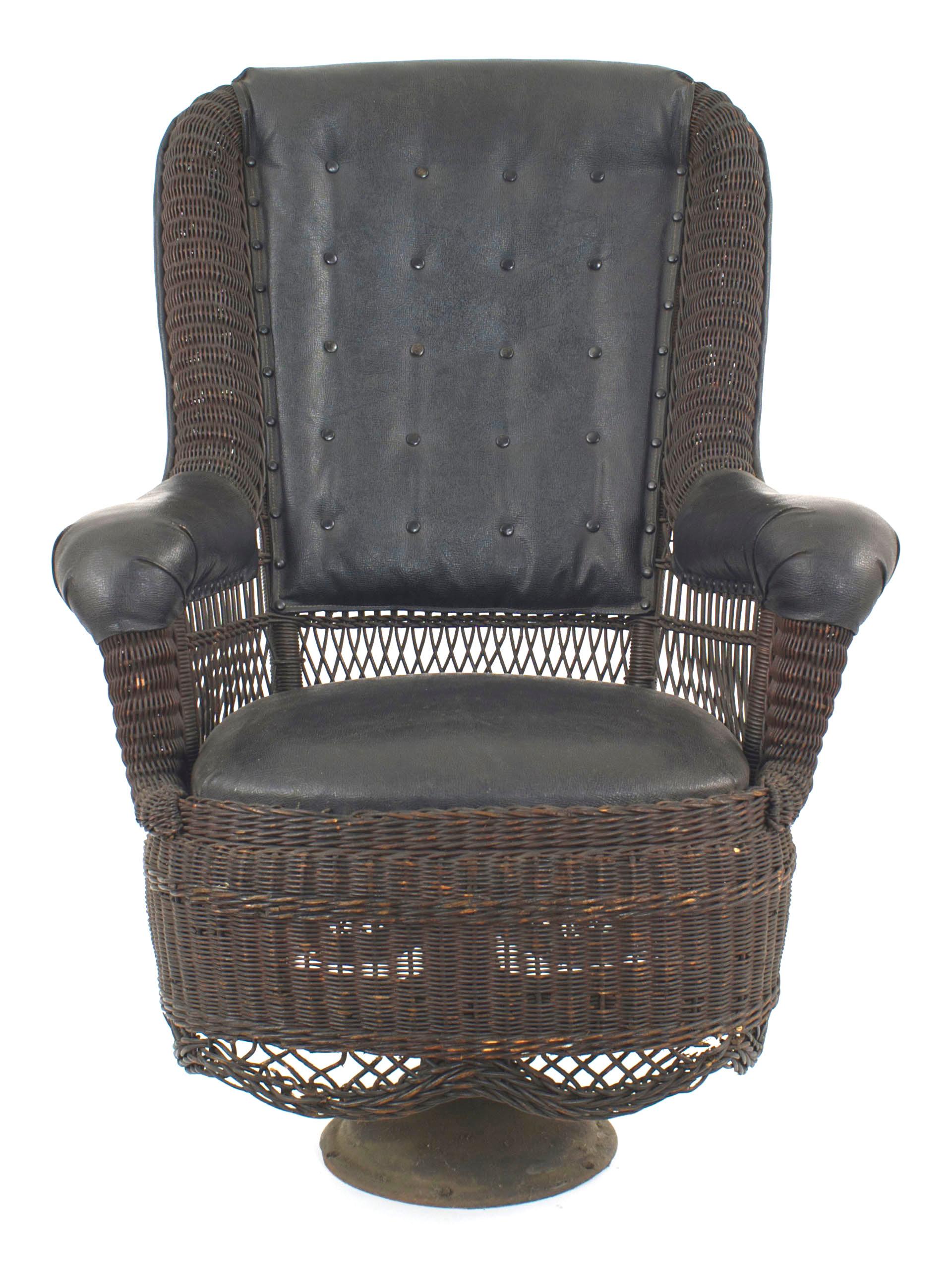 American Victorian stained natural wicker arm chair on round iron swivel base with black leather upholstered seat and back. (Provenance: President Calvin Coolidge's private railroad car on the Boston & Maine Railroad).
