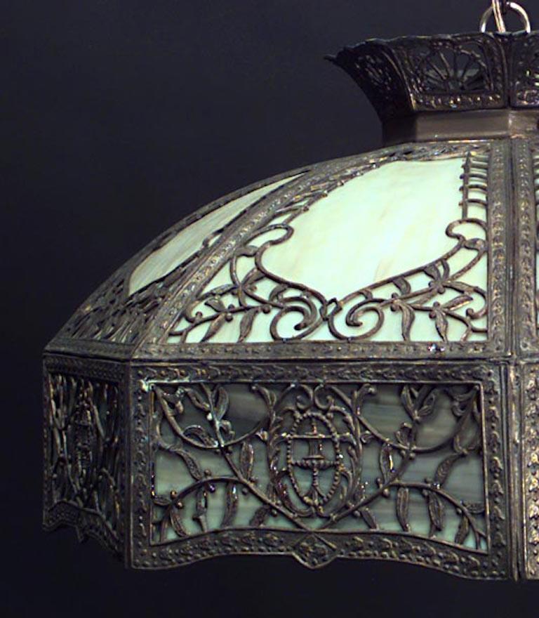 American Victorian Tiffany-Style stained glass hanging shade with bronze filigree design and green glass edge.
