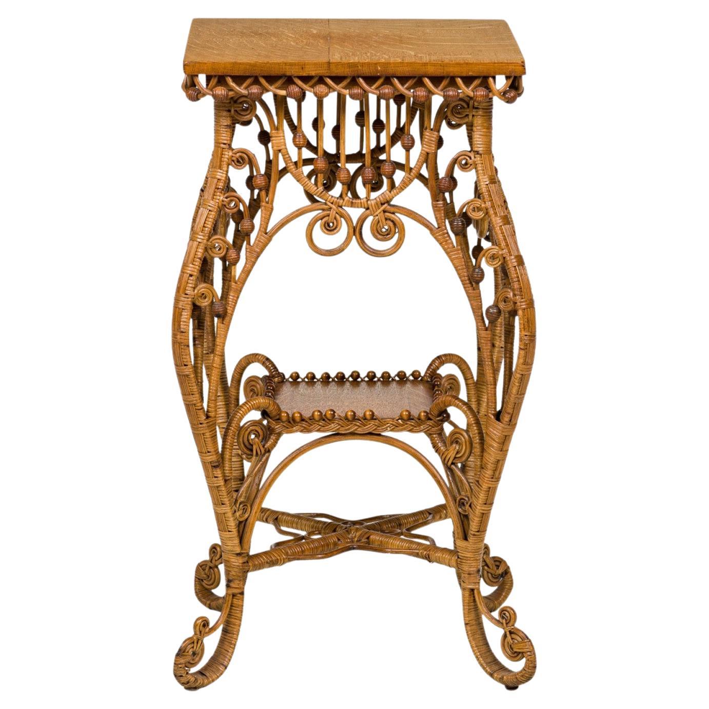 American Victorian Wicker and oak topped square side table with splayed, wicker-wrapped scroll legs, openwork decorative apron, X-stretcher base and beaded stretcher shelf.(att: HEYWOOD WAKEFIELD).