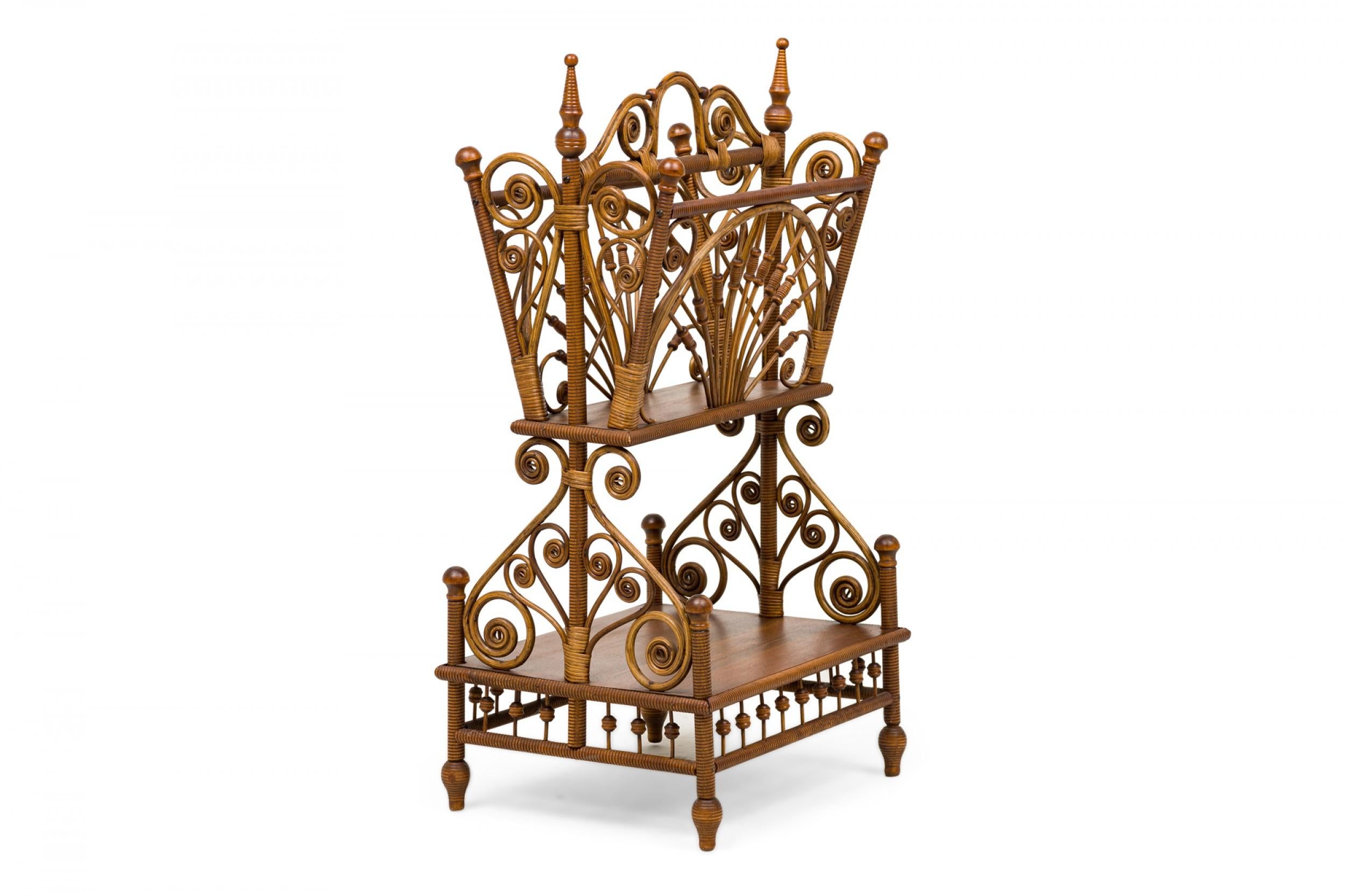 American Victorian Wicker and wood 2-tiered magazine stand with a rectangular stretcher shelf, with openwork decorative scroll motif and turned finials and feet. (att: HEYWOOD WAKEFIELD).