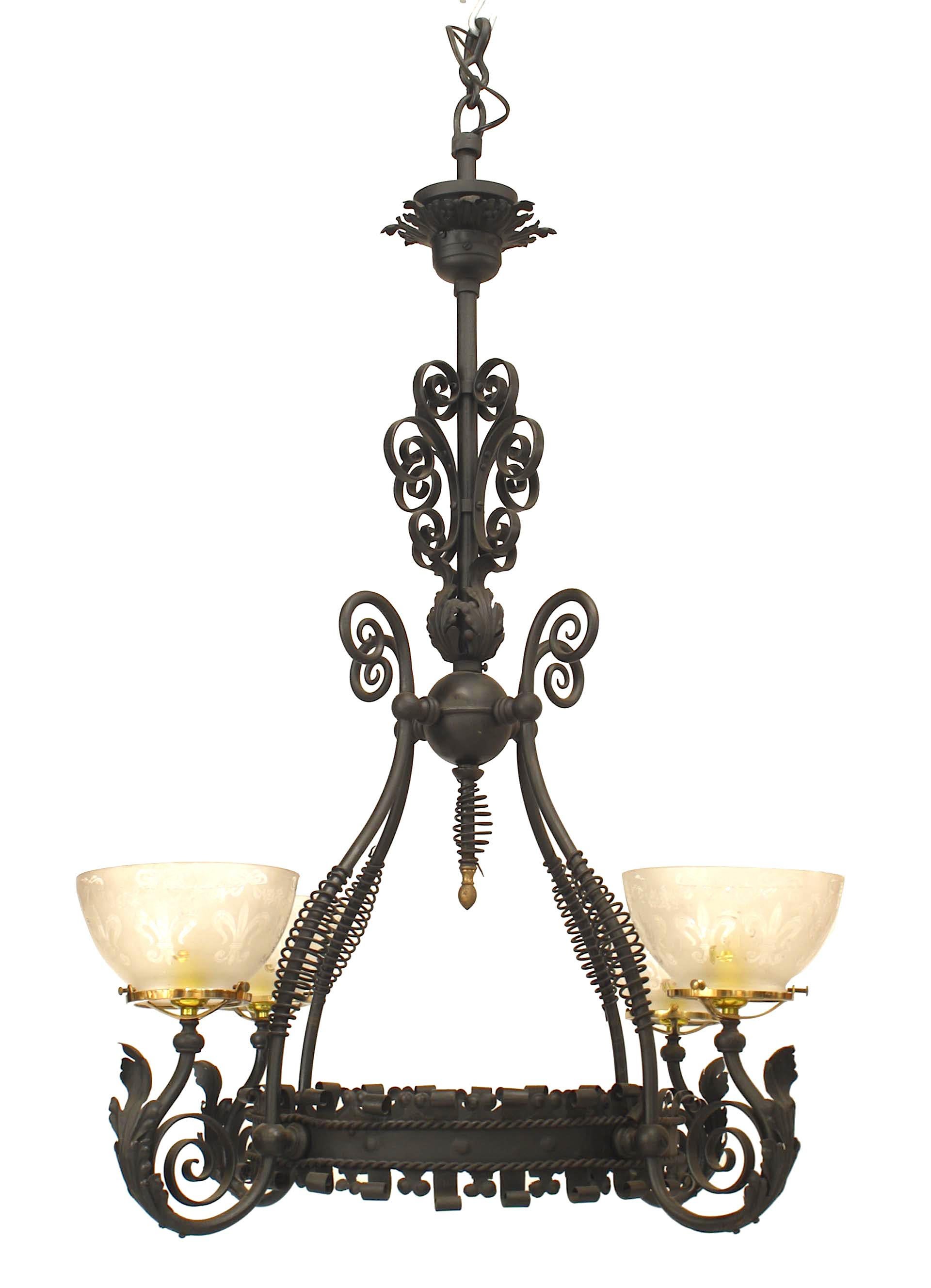American Victorian wrought iron chandelier with 4 scroll design arms extending from a scalloped edge ring form center with etched frosted glass bowl shades.
