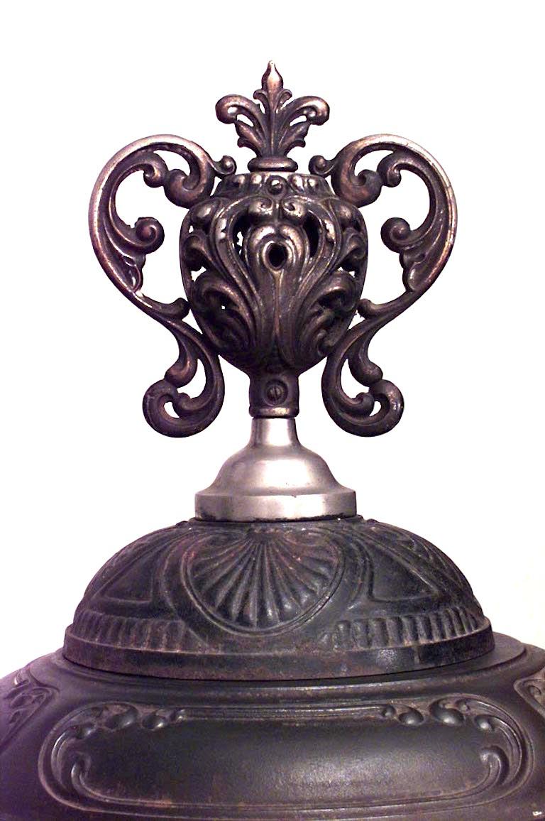 American Victorian round wrought iron pot belly stove with urn finial and steel rim (14 sections *Magee Furnace Co., Boston, Mass)
