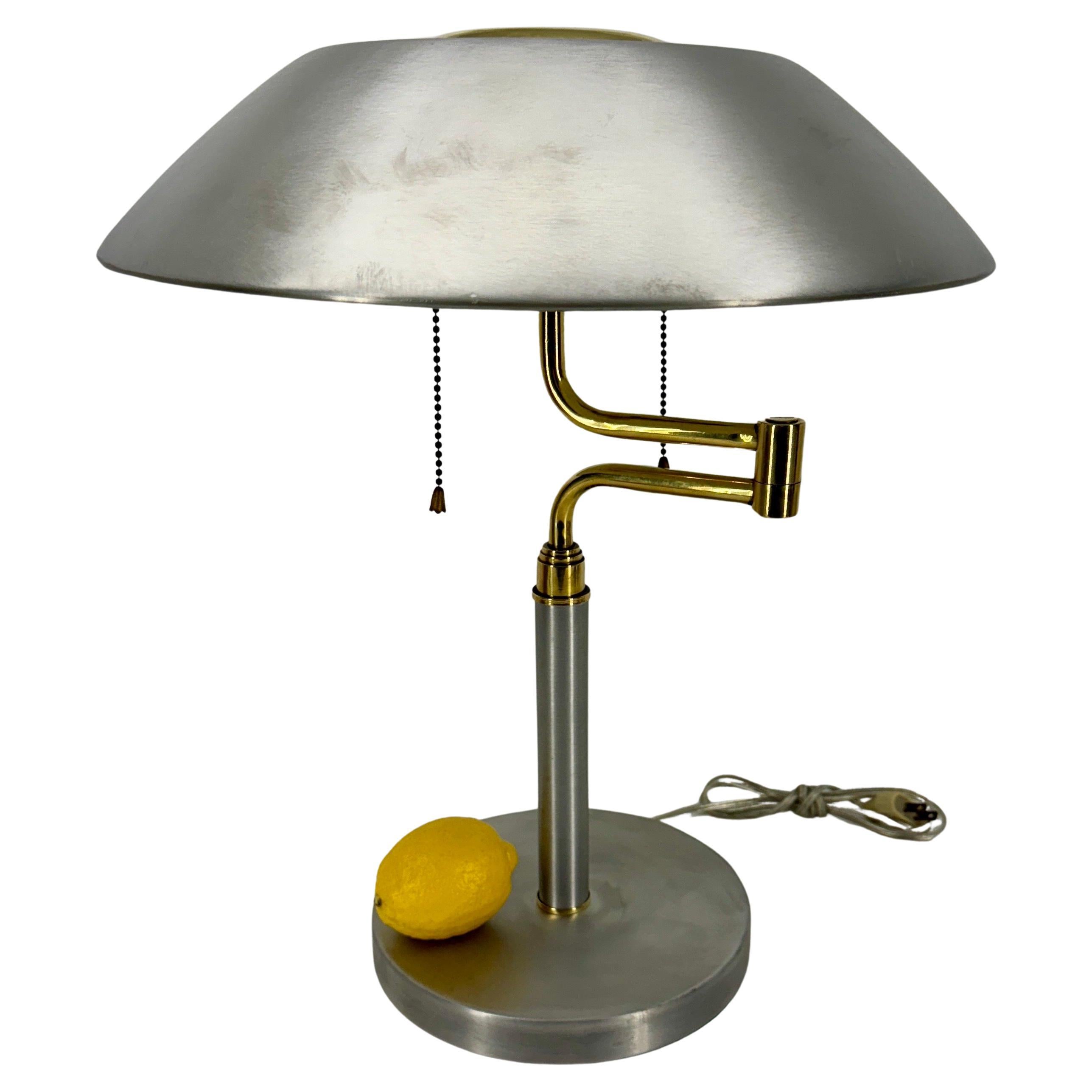 Vintage Brushed Aluminum and Brass Office Desk Lamp, Mid-Century Modern.
The arm and shade of the lamp swings out to a total max lamp width of 20,75 inches.