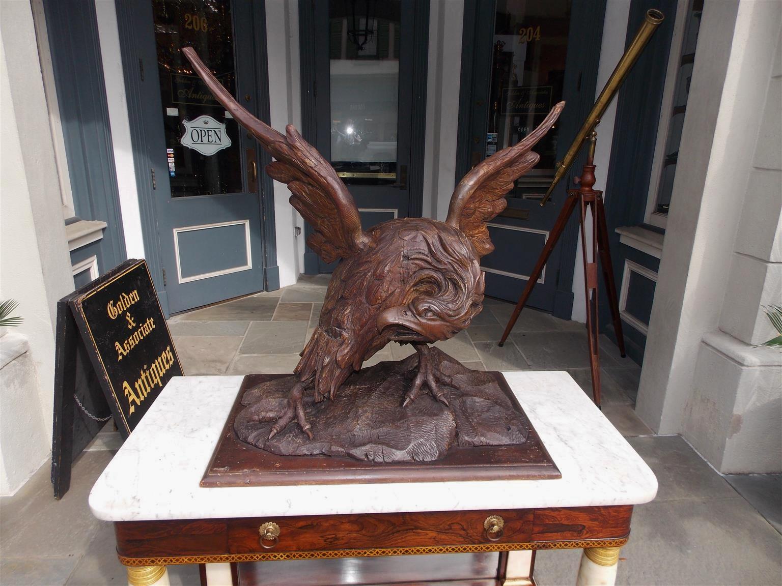 Hand-Carved American Walnut Carved Spread Wing Eagle Perched to Flee on Rocky Plinth C. 1830 For Sale