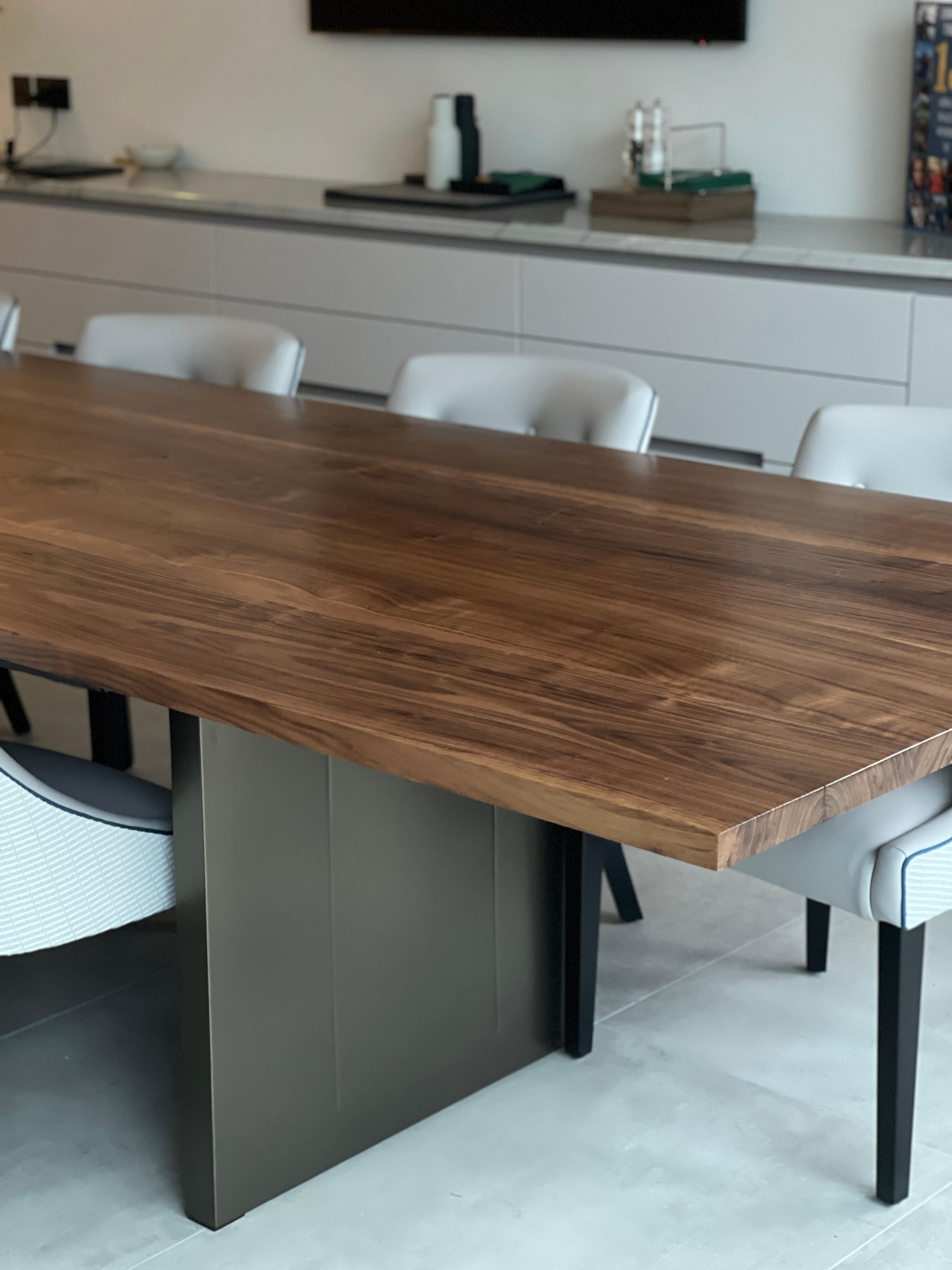 Here you have a 1/1 American Walnut dining table on custom steel etched panel legs that are powder coated bronze.
Photographed so you can see it in situ.

Finished in a very subtle but hard wearing super matte lacquer.

Every item is made-to-order