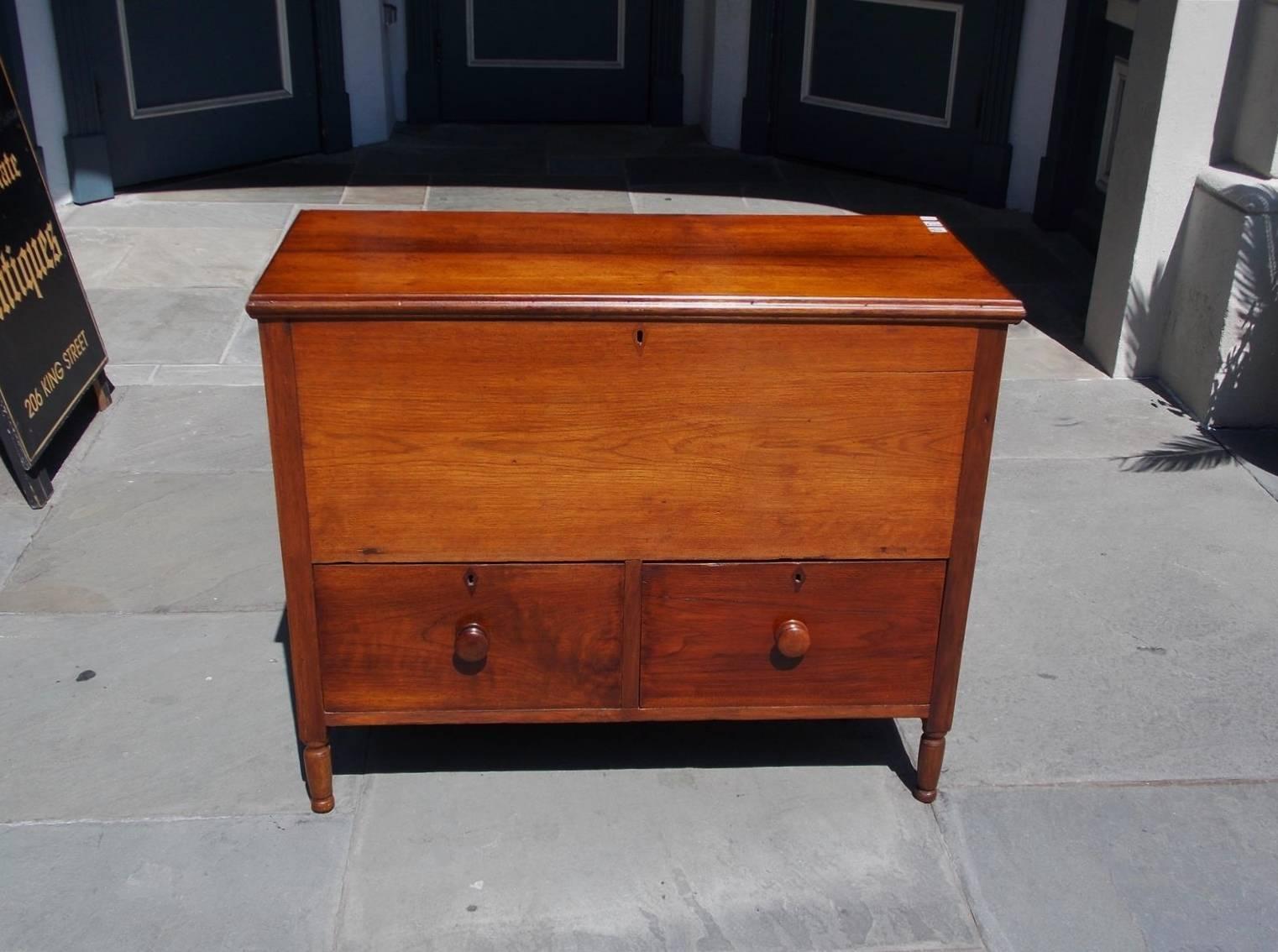 American walnut hinged top sugar chest with compartmentalized interior, two lower case drawers with the original wooden knobs, and resting on the original turned bulbous legs, Early 19th century. Secondary wood consist of poplar and white