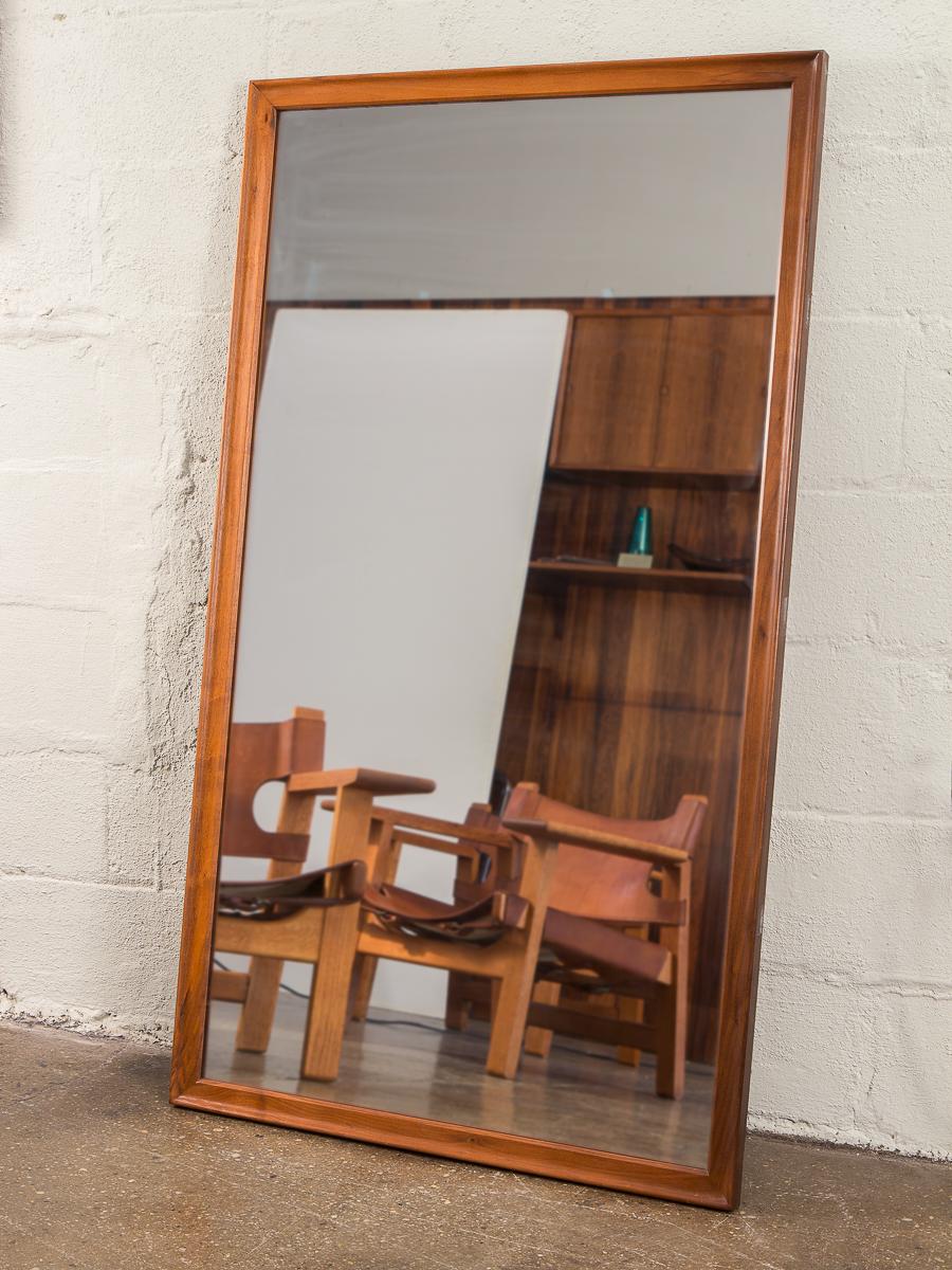 1960s, full length American walnut modern floor mirror. A substantially heavy piece that is sturdy as it is attractive. The walnut wood frame is gleaming and in excellent condition. Large glass pane is exceptionally clean, with no scratches.
