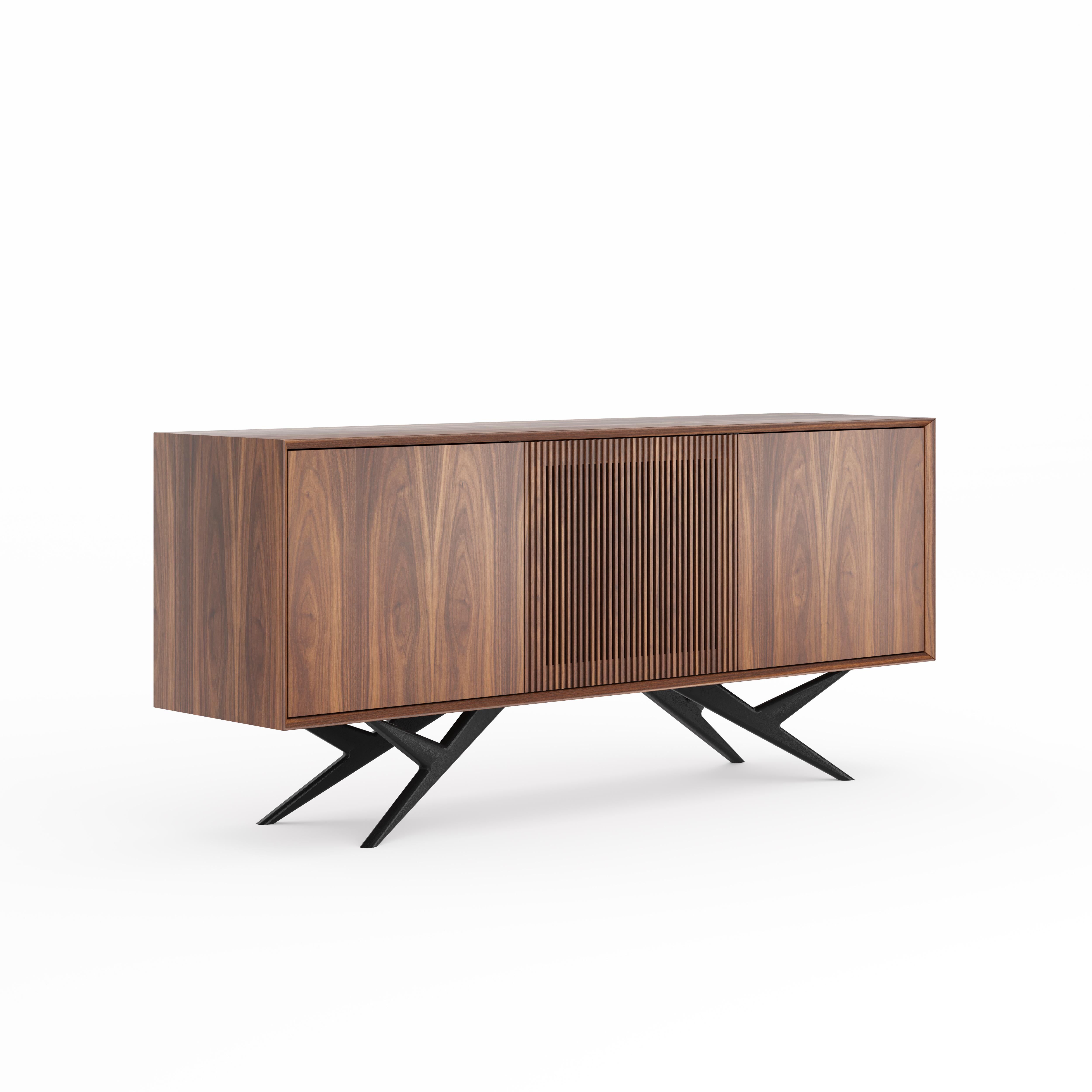La credenza GRIESEL di THALLORIS è una credenza in noce americano fatta a mano di qualità superiore, pensata per soggiorni moderni, sale da pranzo e interni di lusso. Facente parte dell'esclusiva collezione GRIESEL, questo elegante pezzo combina