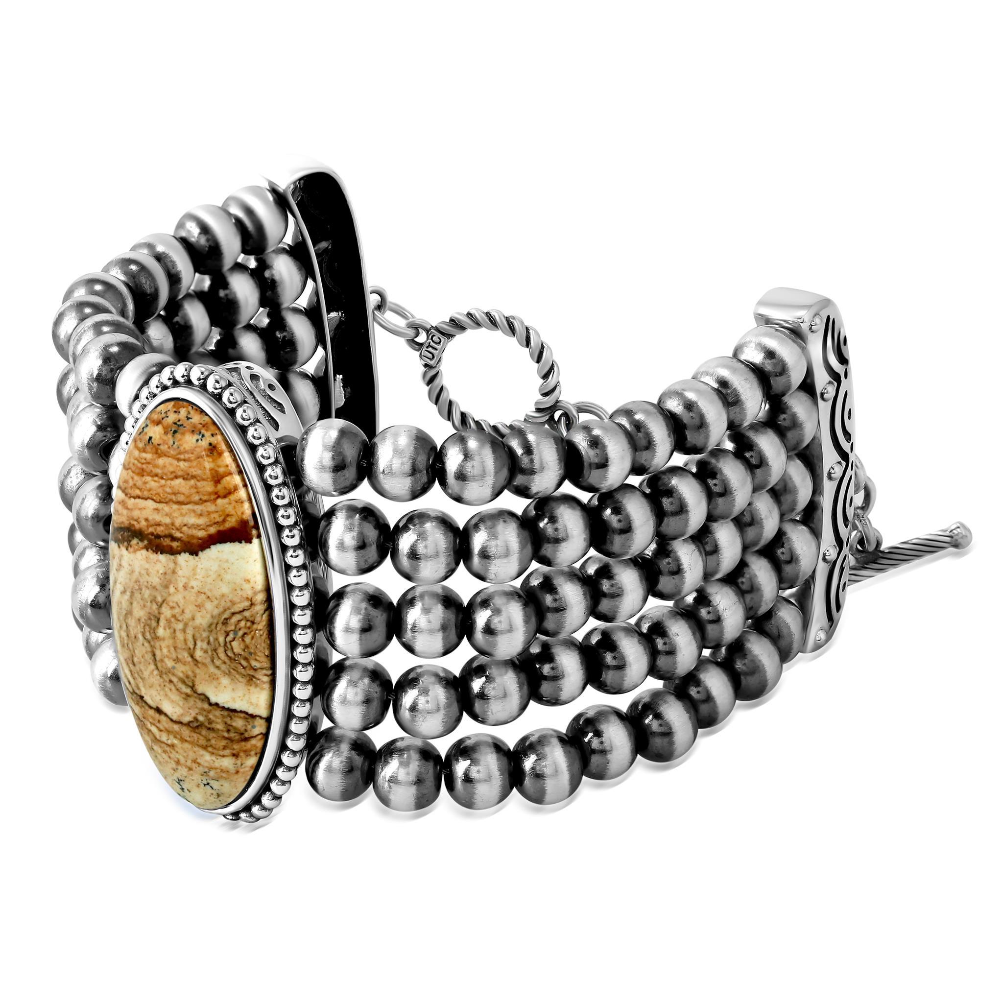 - La pulsera incluye un atrevido cabujón ovalado de piedra preciosa Jaspe de 16 mm x 36 mm con un marco de bisel con cuentas; 5 filas de cuentas de plata de ley de 6 mm oxidadas y pulidas
- Cierre de palanca y barra; Pequeño para muñecas de 6,25