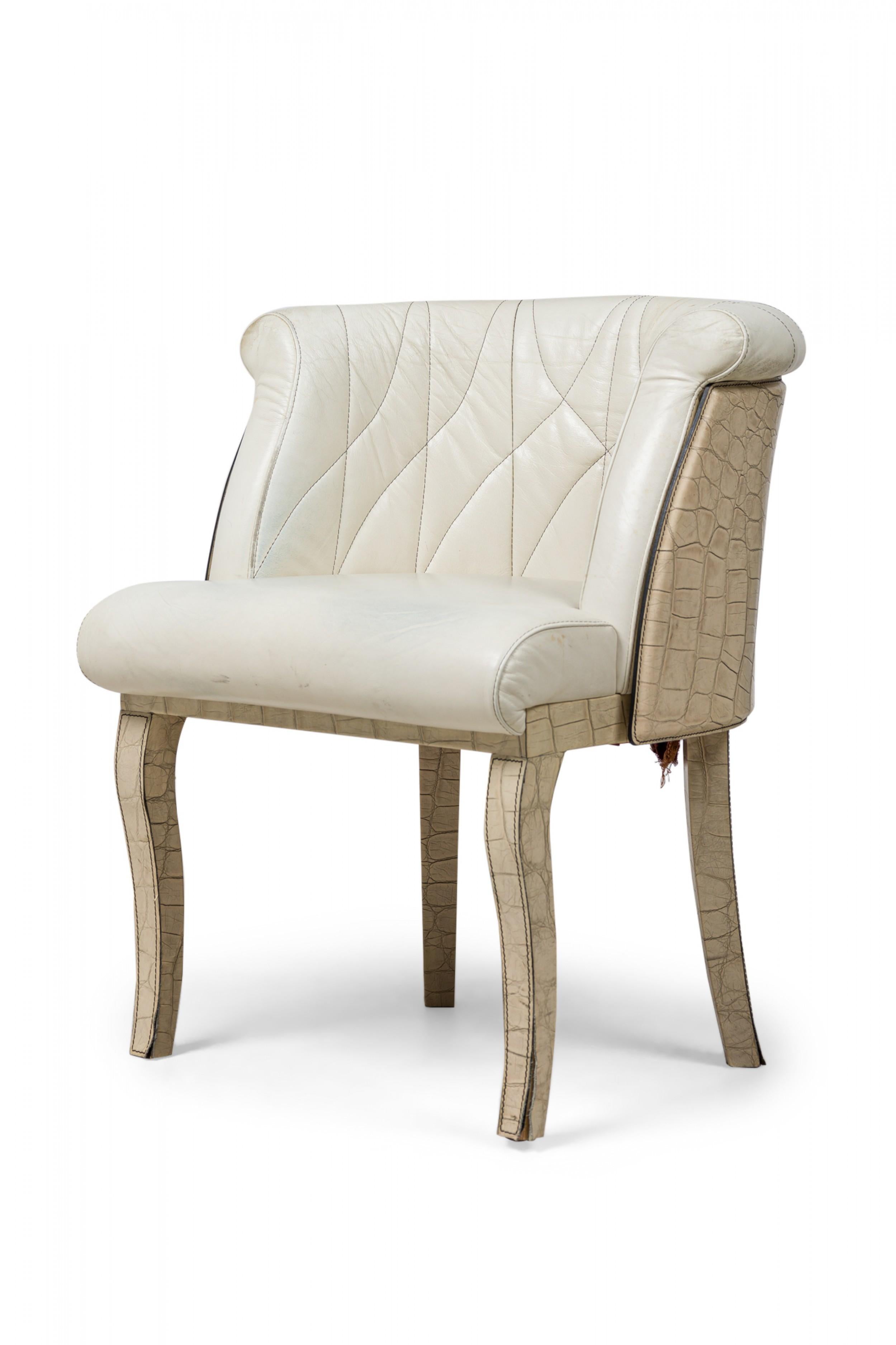 Midcentury American faux snakeskin dining / side chair with a curved back, padded seat overlapping the back, quilted and upholstered in beige leather, standing on 2 front cabriole legs and slightly splayed back legs.