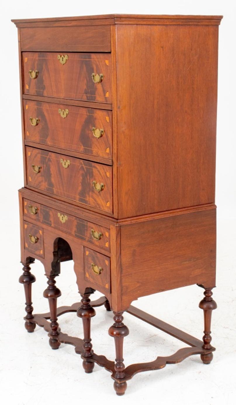 American William & Mary style chest on stand, largely late 19th century,  the upper section with three drawers, above a base with a central drawer above a kneehole flanked by two short drawers, on turned legs joined by a shaped stretcher. 73
