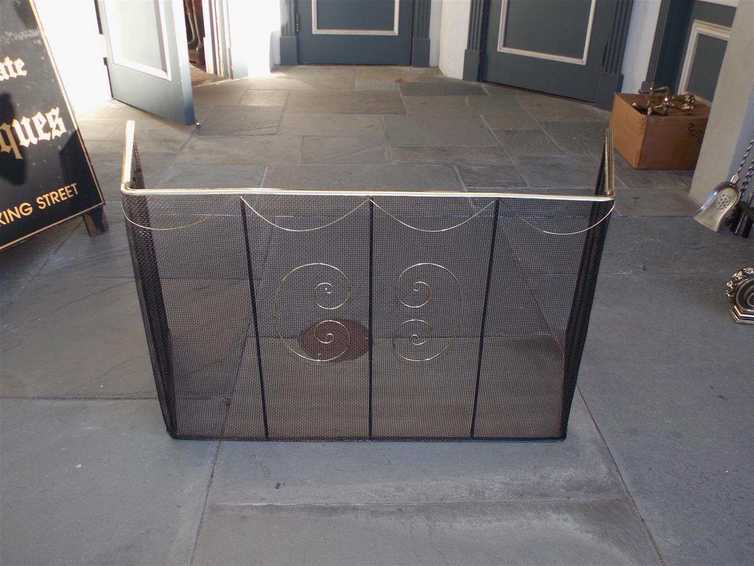 American wire and brass rail top hinged nursery screen with pleasing decorative brass swags, flanking exterior decorative brass scroll wire work, and interior wrought iron support columns, Late 18th century.
  