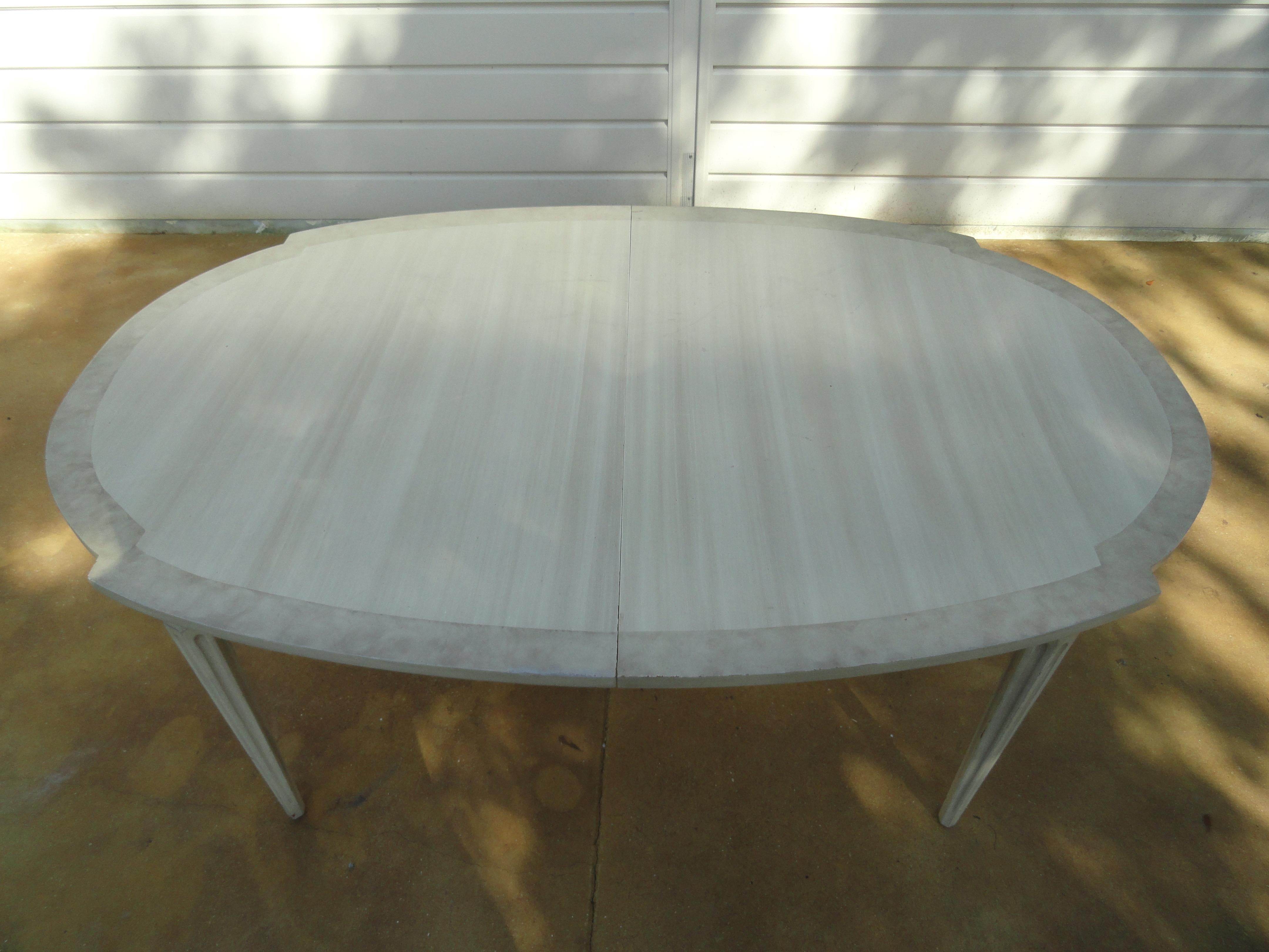 American wood painted dining table with two leafs. Scandinavian influenced painted table with gray and white with a beautiful border. Table has a continuous apron with the leafs inserted. Legs are fluted. Solid table of maple and burl wood. American
