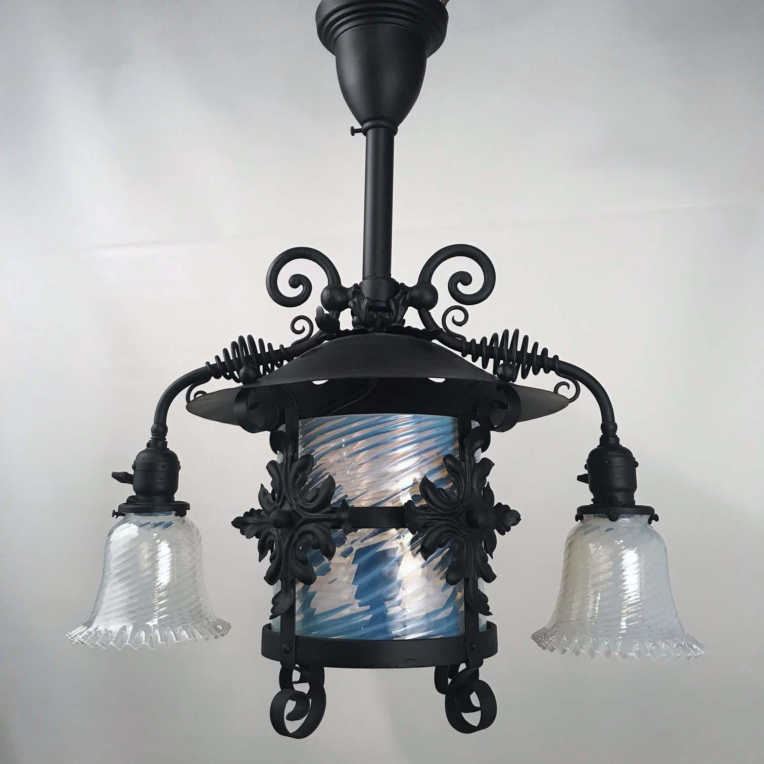 This highly unusual lantern dates from a time when both gas and electricity were available, the last quarter of the 19th century. The central part was once gas but is now electric, the shade is a cylinder of wrythen opaline glass, flanked by a pair
