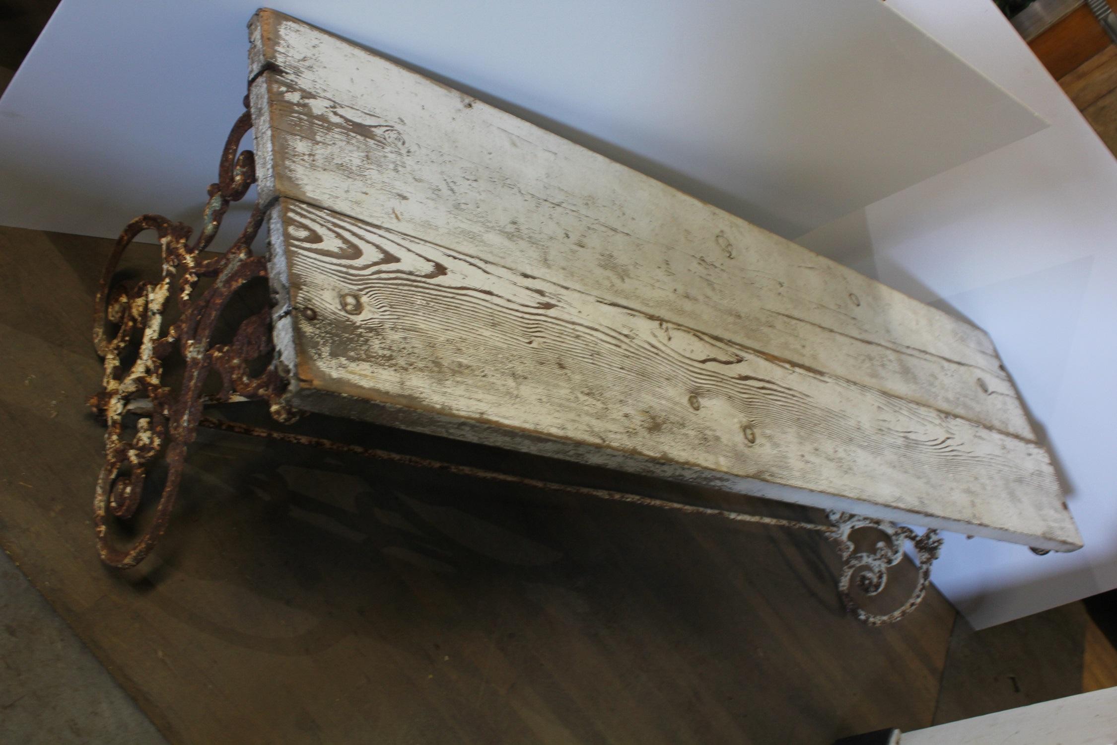 American wrought iron and wood base table or bench, circa 1900s.