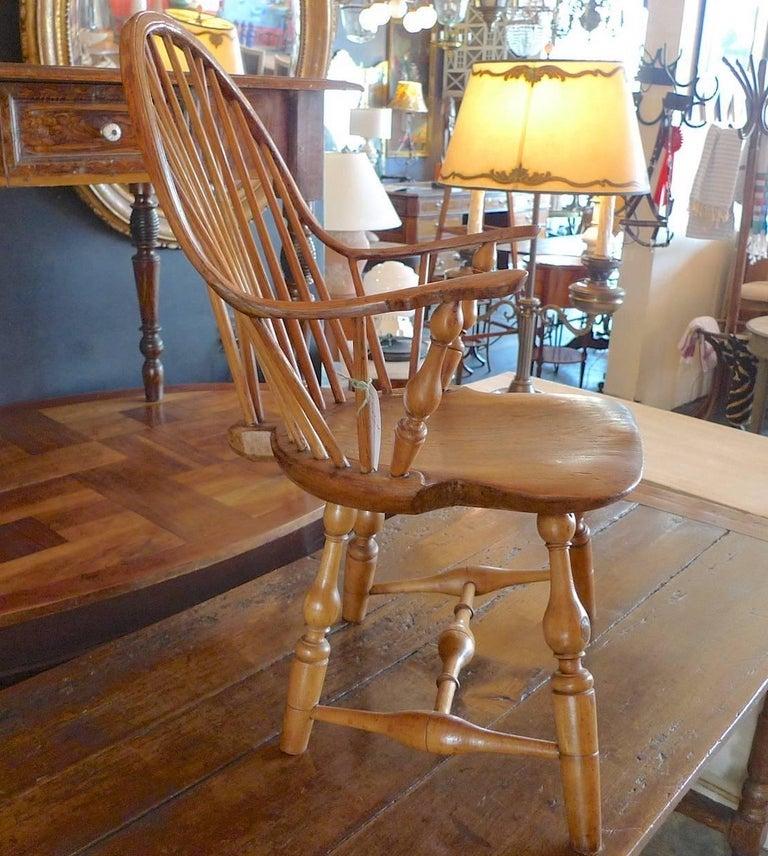 American 18th century windsor continuous armchair. Vase and ring-turned supports on shaped saddle seat with tail piece splayed vase and turned legs. Signed by J Caldwell.
  