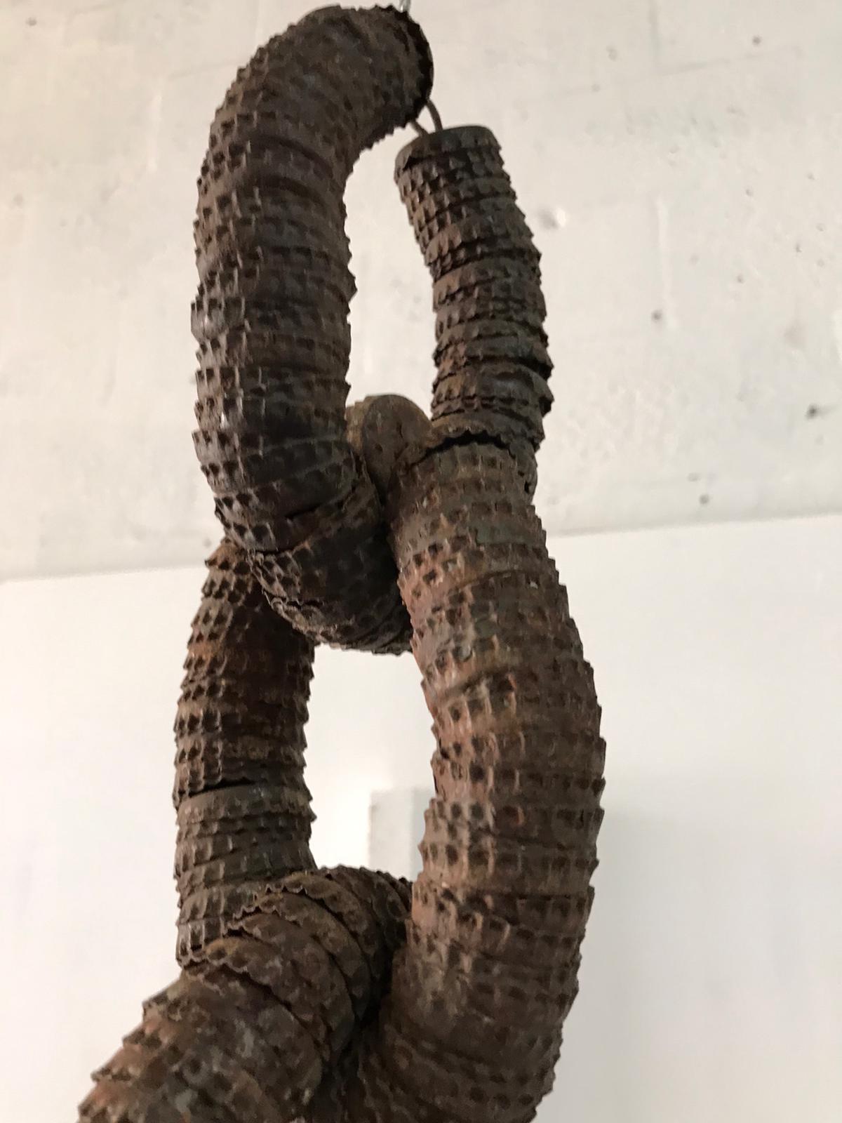 This Folk Art hanging sculpture made of vintage bottle caps hand strewn in to this chain-link piece of art. This can be hung from any height, leaving the base to coil around in a natural and artistic way. This is not new, truly an antique piece of
