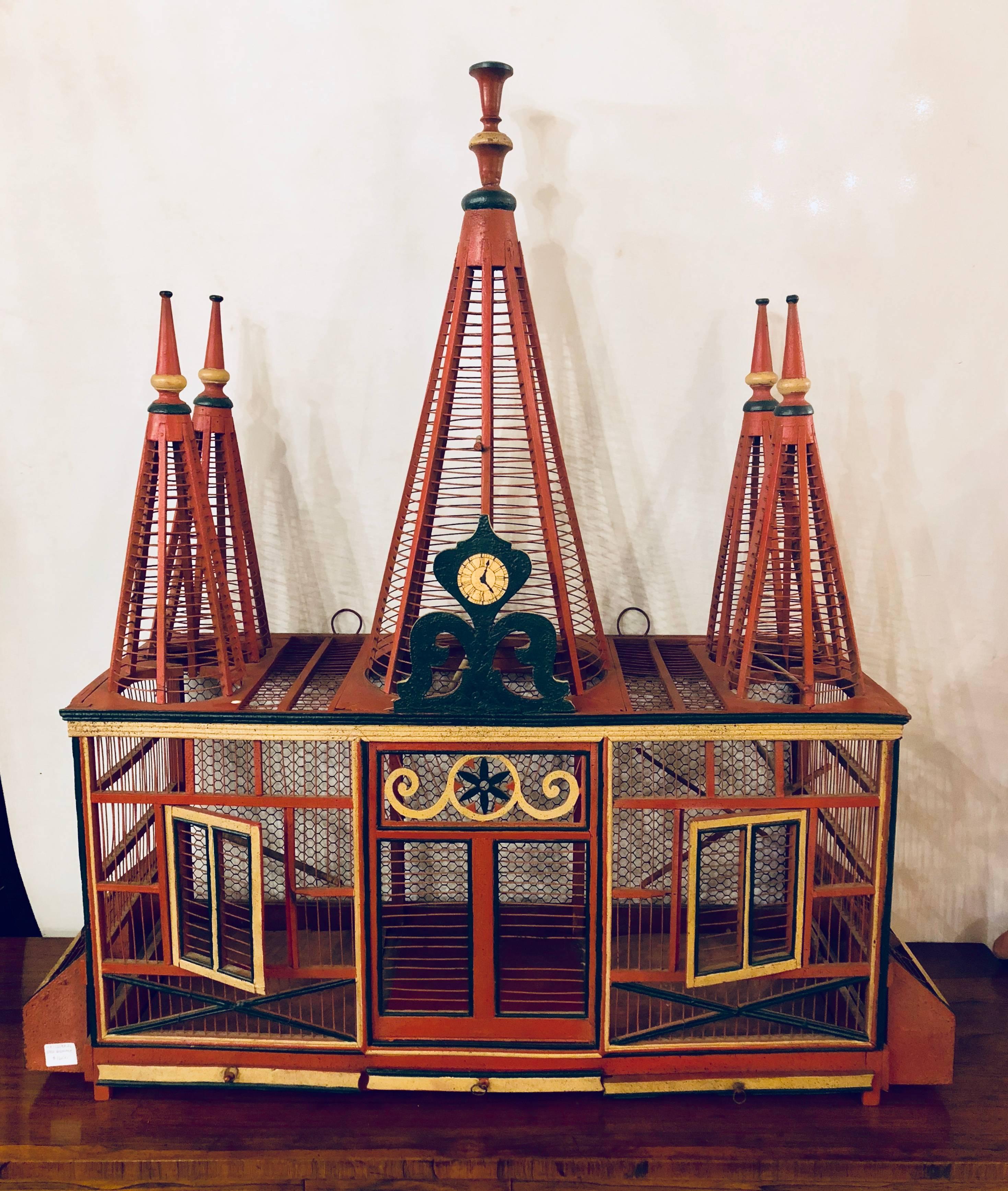 An Americana Folk Art original painted bird cage. In bright vibrant original paint comes this circus tent formed bird cage.