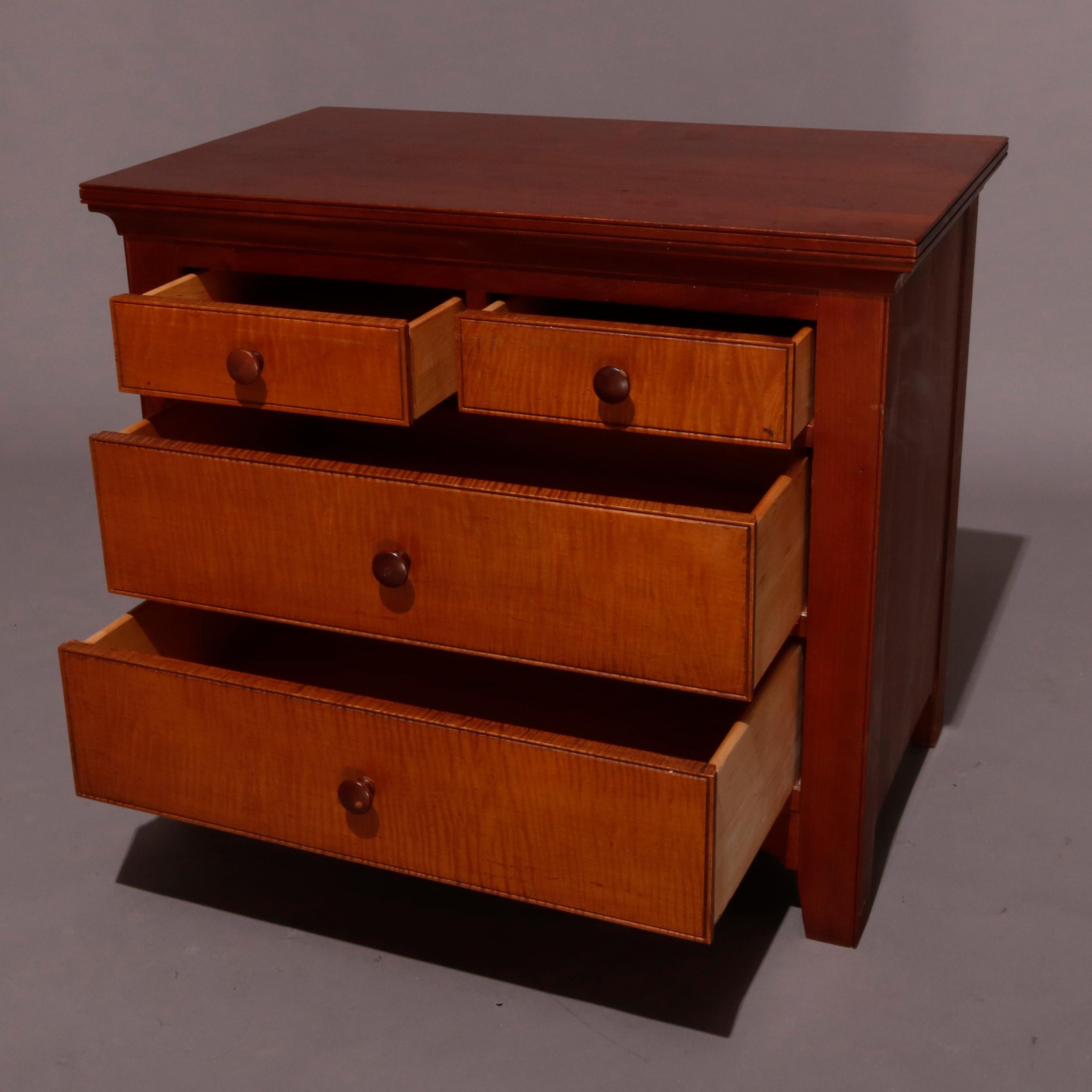 An Americana Shaker Style diminutive chest features cherry construction with two smaller over two long tiger maple front drawers, 20th century

Measures: 26