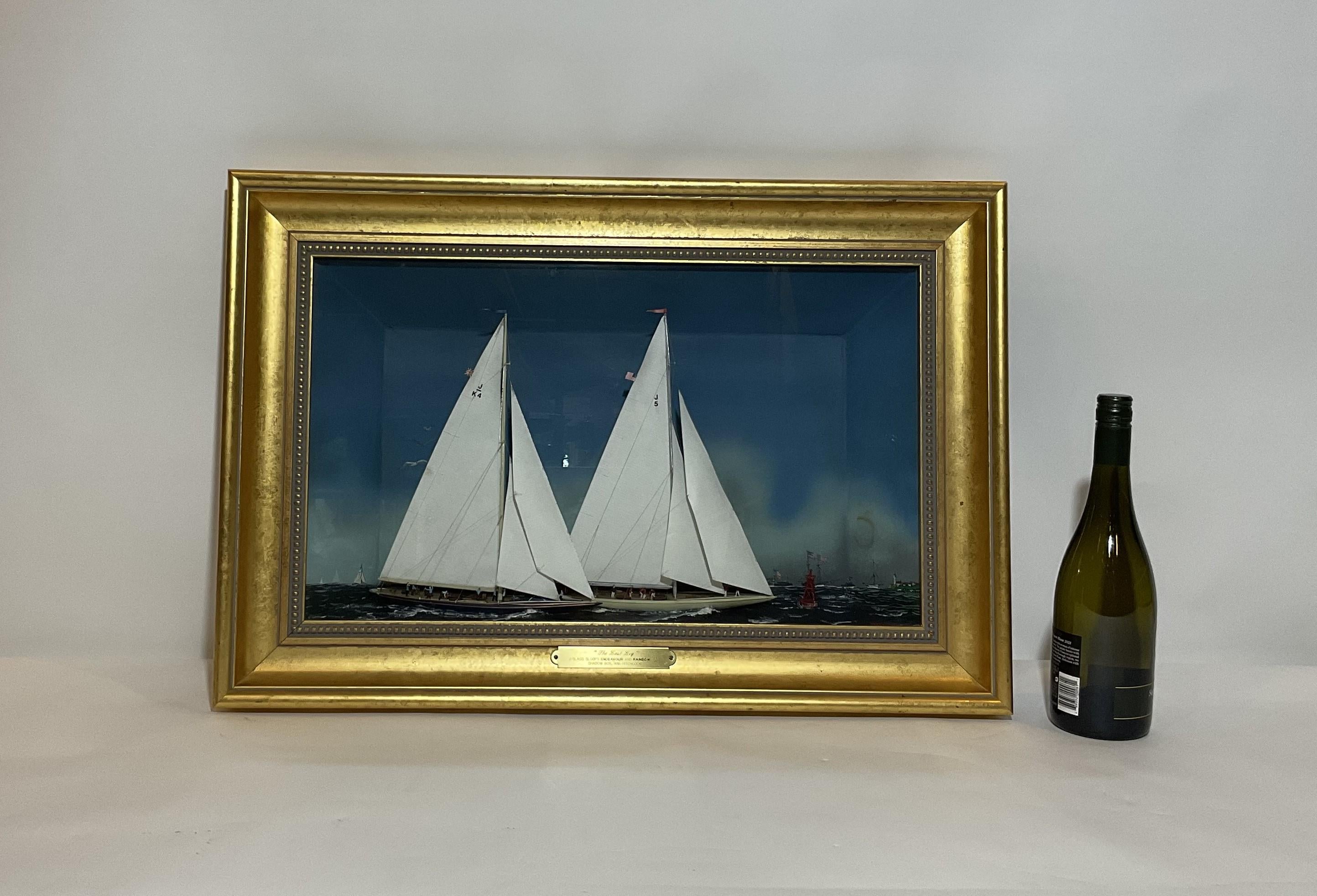 William Hitchcock diorama showing the 1934 America's Cup Final with Endeavor and Rainbow racing past a buoy under full sail with crews on board. Highly detailed by a diorama expert. Painted background with ships. Mounted into a shadow box bracketed