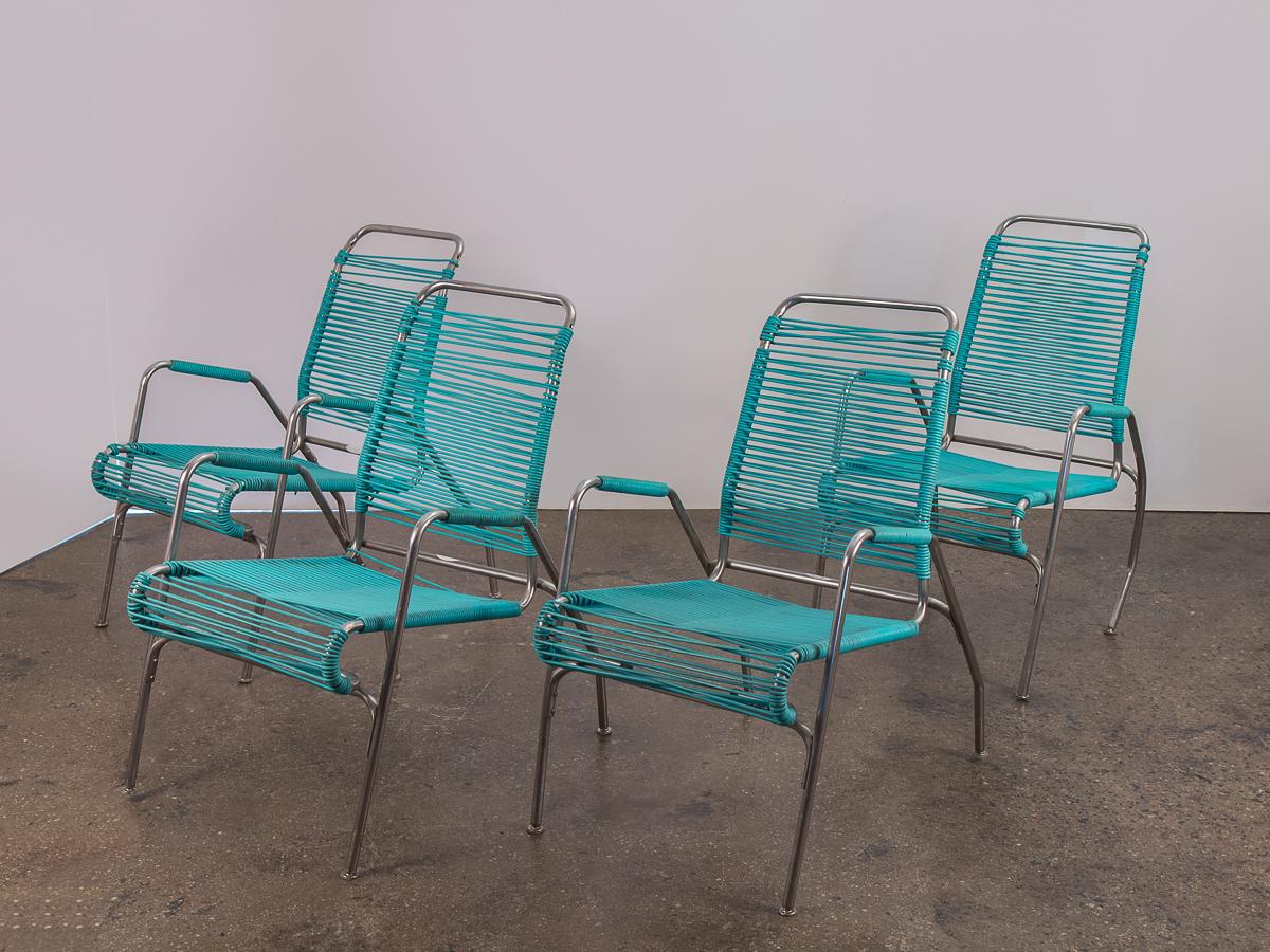 1960s Ames Aire set of four patio chairs with teal vinyl cording. Add this fun, modern set to your patio or garden for colorful, mod flare. Chairs are in good vintage condition, and have been lovingly used. Vinyl cording has age-appropriate wear,