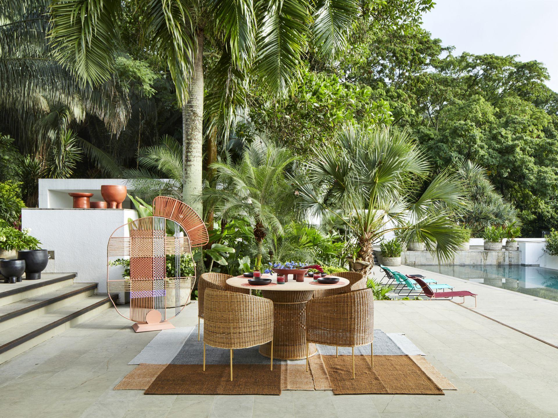 The Caribe Natural Dining Table is a design by Sebastian Herkner, featuring a beautiful wicker webbing. The shape of the table follows our popular Caribe and Caribe Chic pieces, while the beige hue of the natural material gives it a more subtle