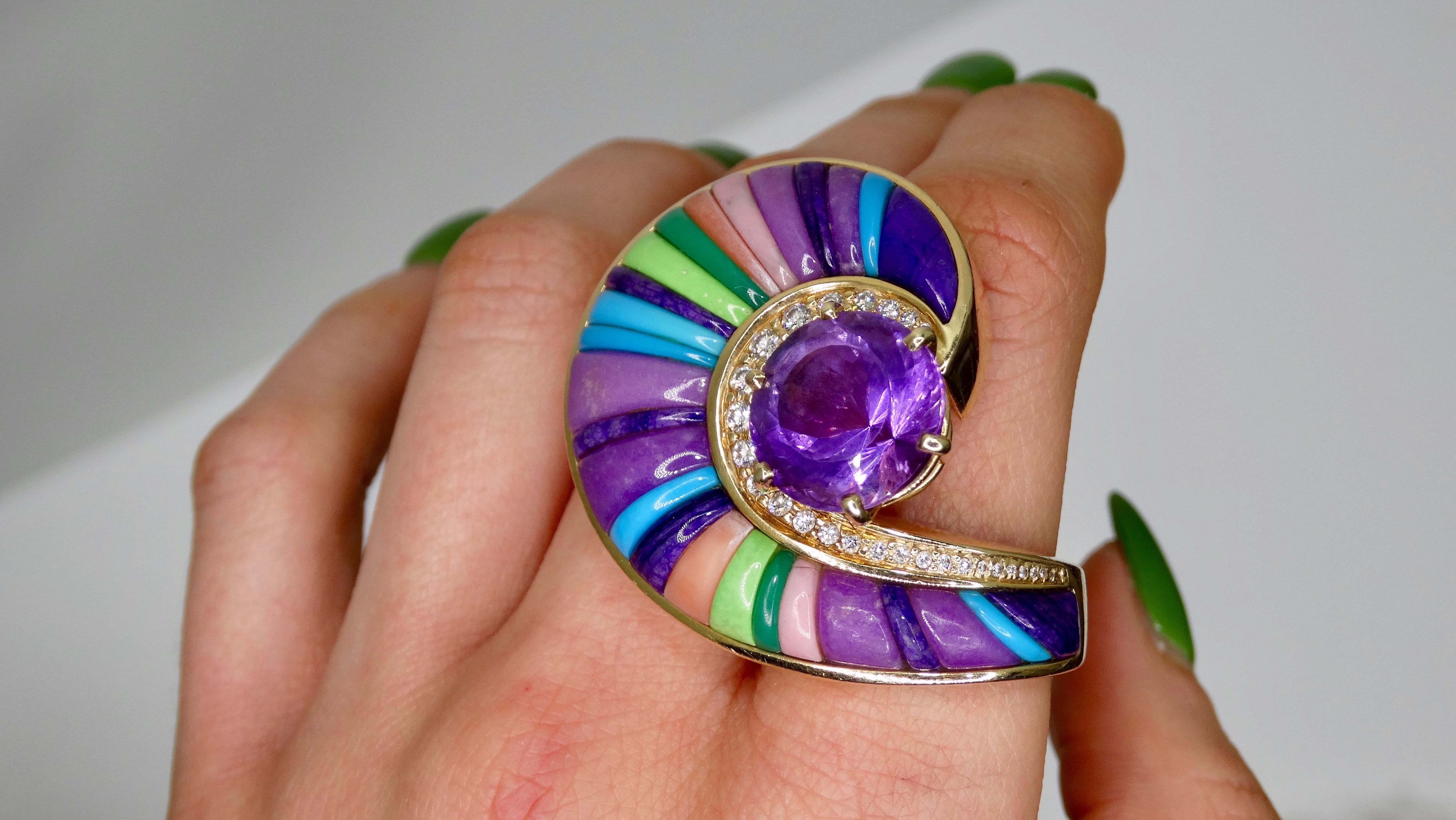All eyes on you with this stunning custom made cocktail ring! Set in a large spiral 14k Gold band is a gorgeous round cut Amethyst ( 13mm round approx. 8.51 carat) in a prong setting with approximately 28 White Diamonds around it. Set in the