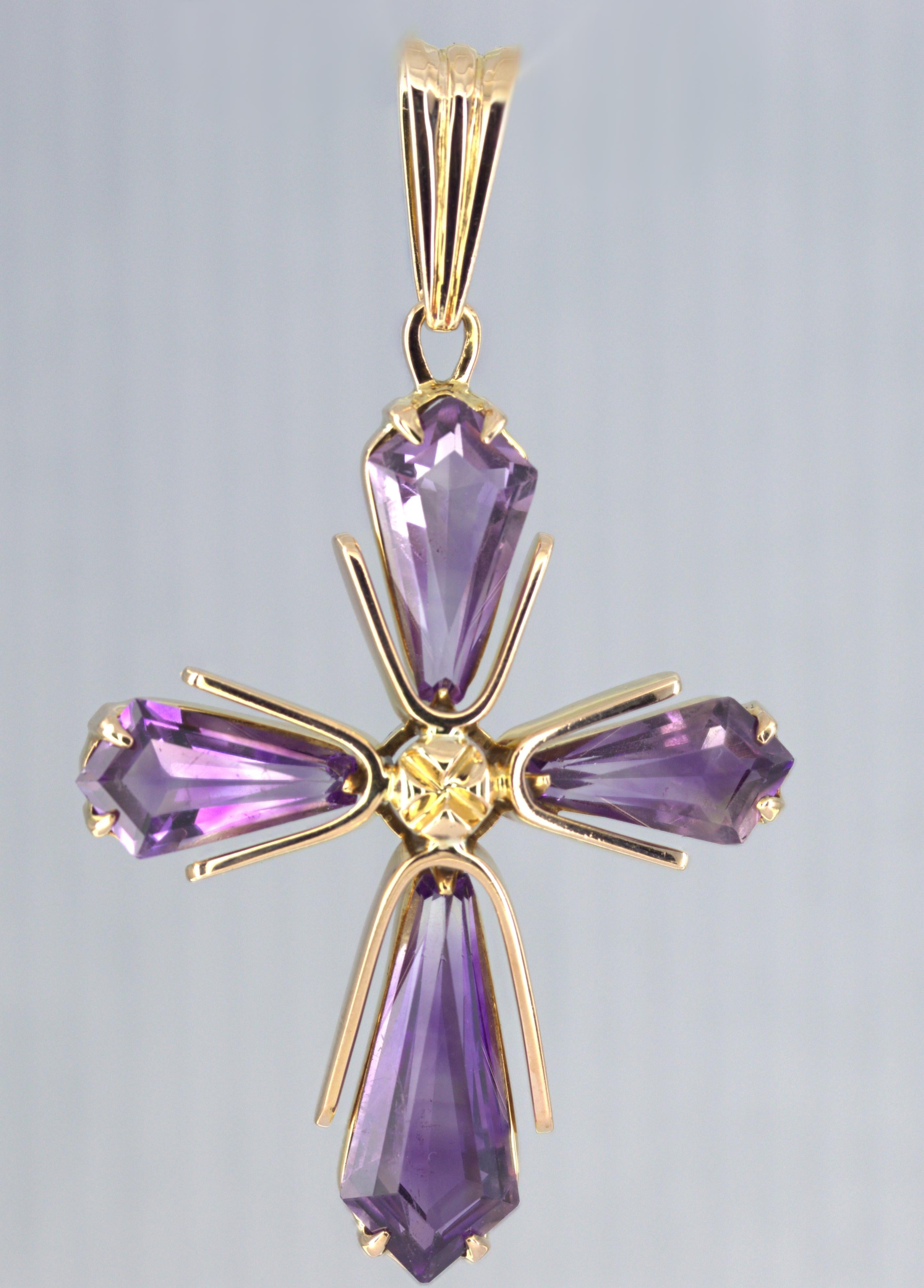 Featuring (4) kite shaped amethysts, 12.60 cts. tw., set in an 14k yellow cross pendant, 43 (53 with bail) X 42 X 6.4 mm, marked 14K, Gross weight 9.39 grams.