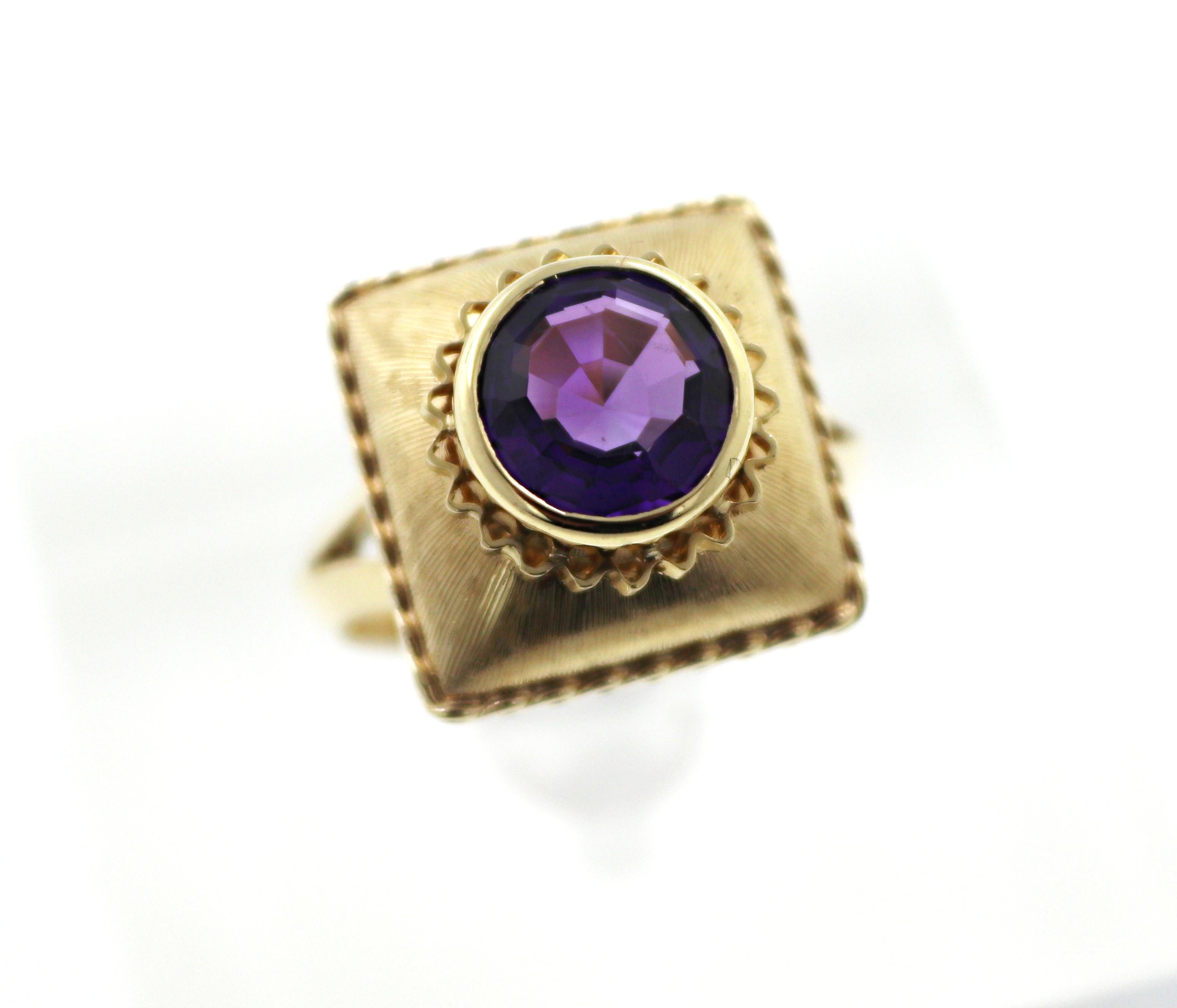 Centering (1) fancy decagon-cut amethyst, 1.65 ct., bezel set in a Florentined 14k yellow gold pillow
motif mounting 15.7 X 15.7 mm, tapering to 2.7 mm, size 8, marked 585, Austrian hallmarks, 6.92 grams.