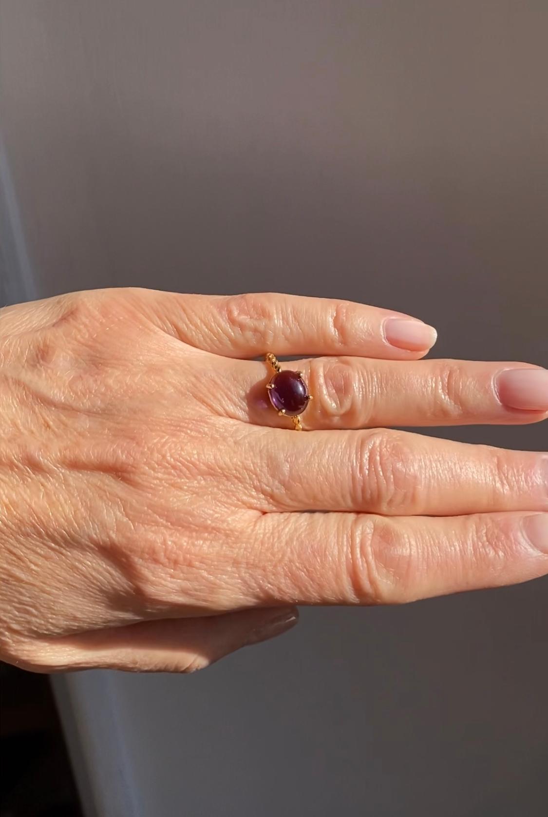 Rossella Ugolini Modern Ring 18K Yellow Gold Handcrafted like a small irregular intertwining of branches that recalls the organic shape of nature. The central stone is an Amethyst oval cabochon cut. Unisex Modern Organic Ring handcrafted with the