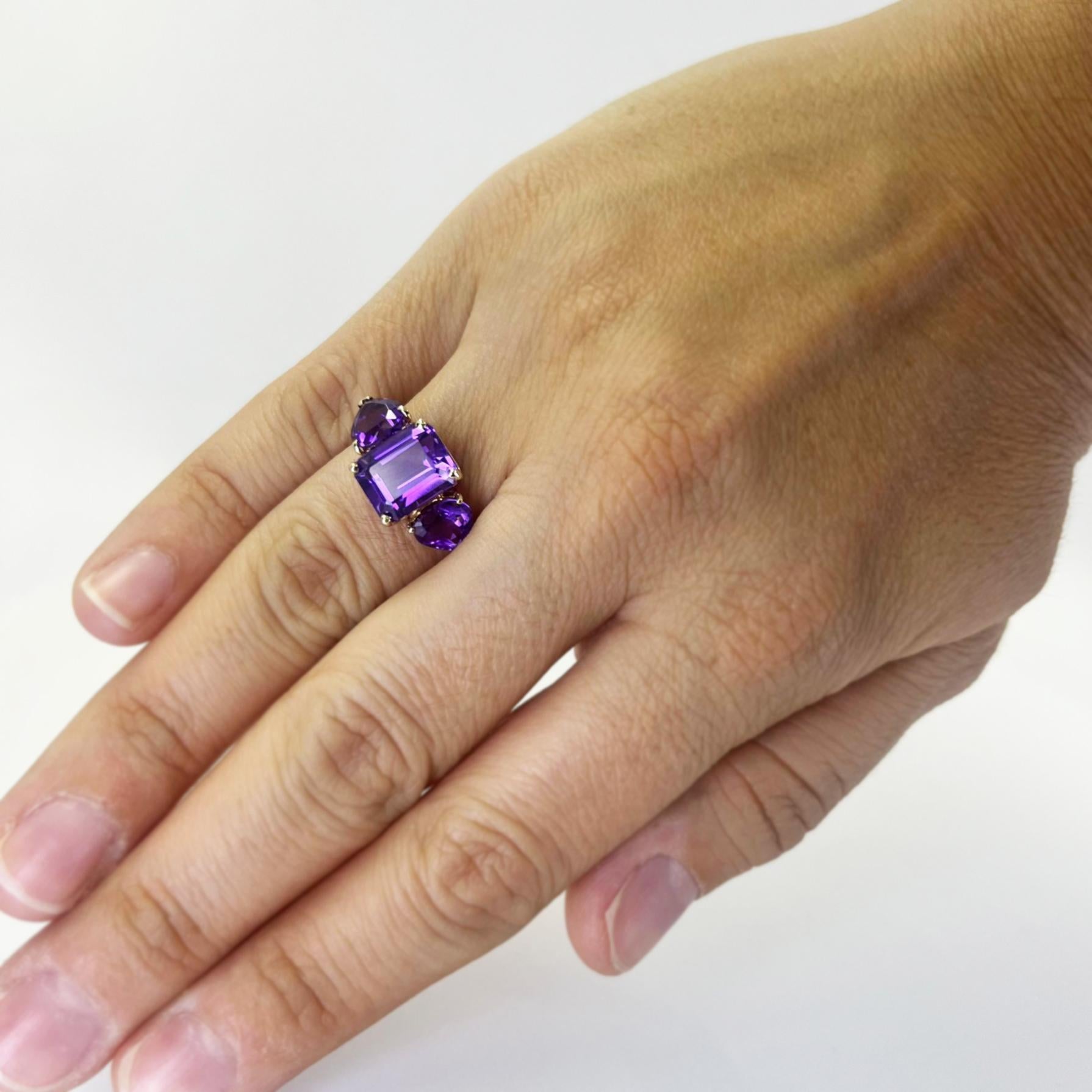 14 karat yellow gold 3 stone ring featuring an emerald cut amethyst and 2 heart shaped amethysts estimated to total approximately 5.00 carats. Finger size 5.75. Includes One Sizing Service Prior to Shipping, Upon Request. Finished weight is 3.5