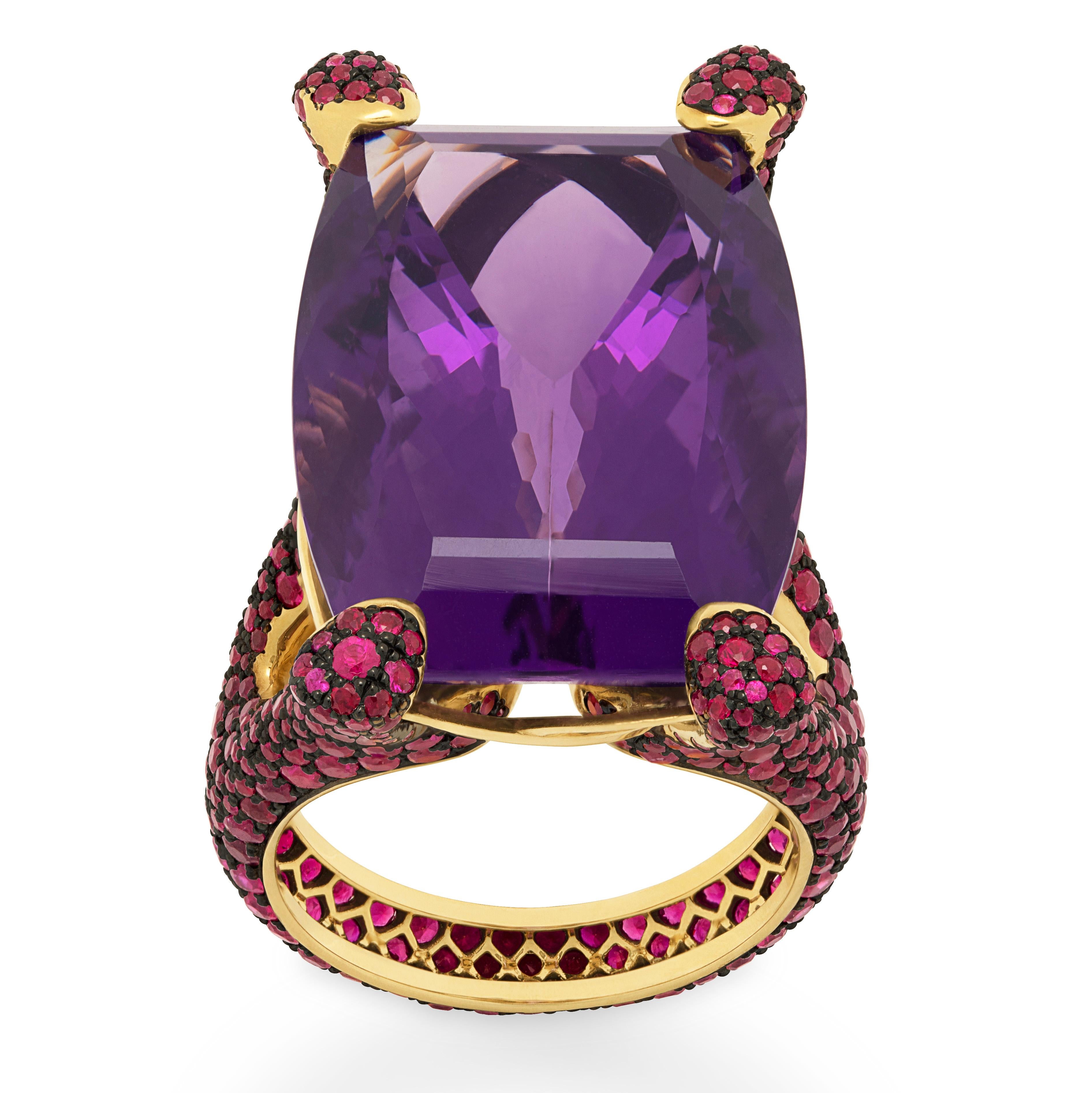 Amethyst 36.85 Carat Ruby 18 Karat Yellow Gold Ring
Highlighting a 36.85 Carat Amethyst and 494 Rubies weighing 5.43 Carats are mounted on an 18 Karat Gold lined with black rhodium. It displays a riveting interplay of contrast surfaces with the