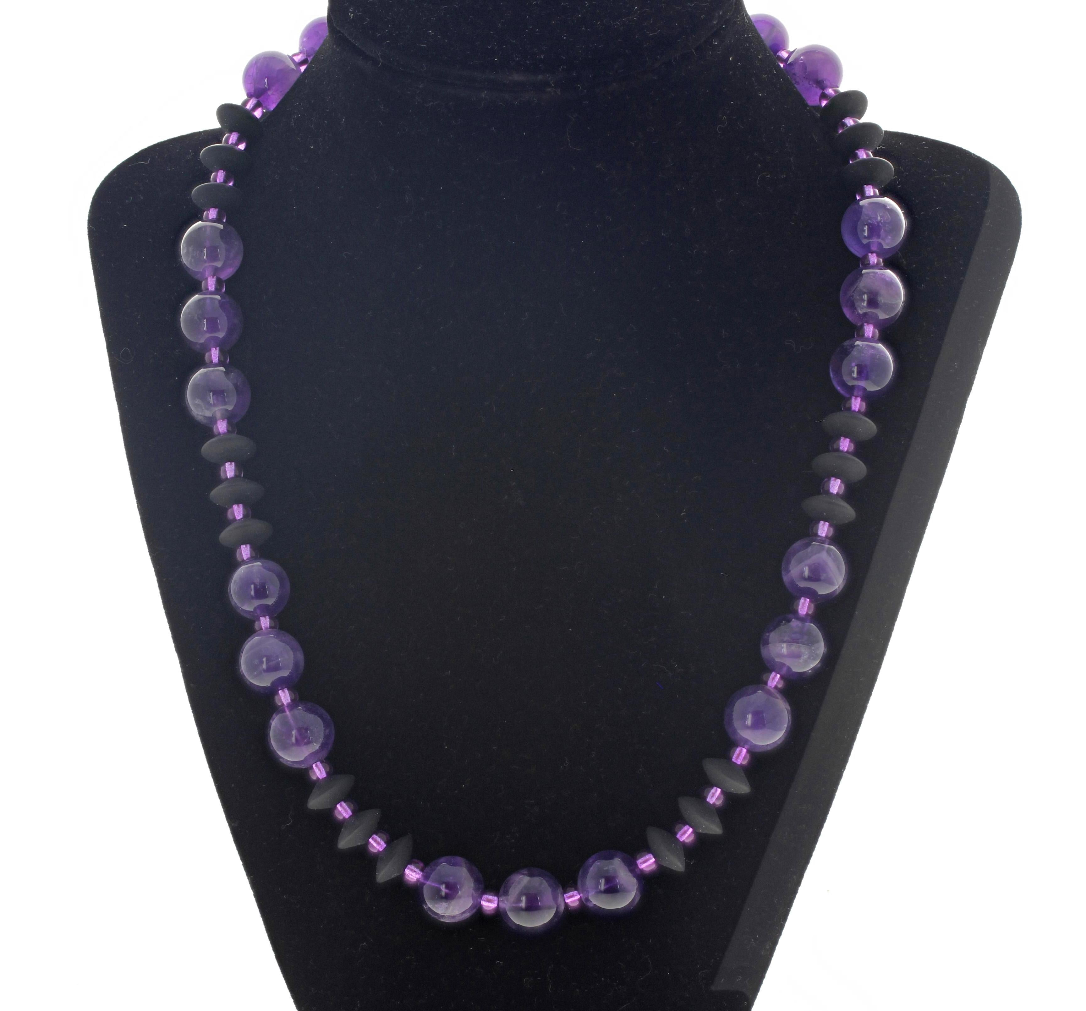 Lovely contrast between these polished Amethyst rocks - approximately 12 mm -  and the Black Onyx enhanced by sparkling glowing Czech purplypink beads.   This bright happy necklace is 20 inches long and has a gold plated hook clasp.  