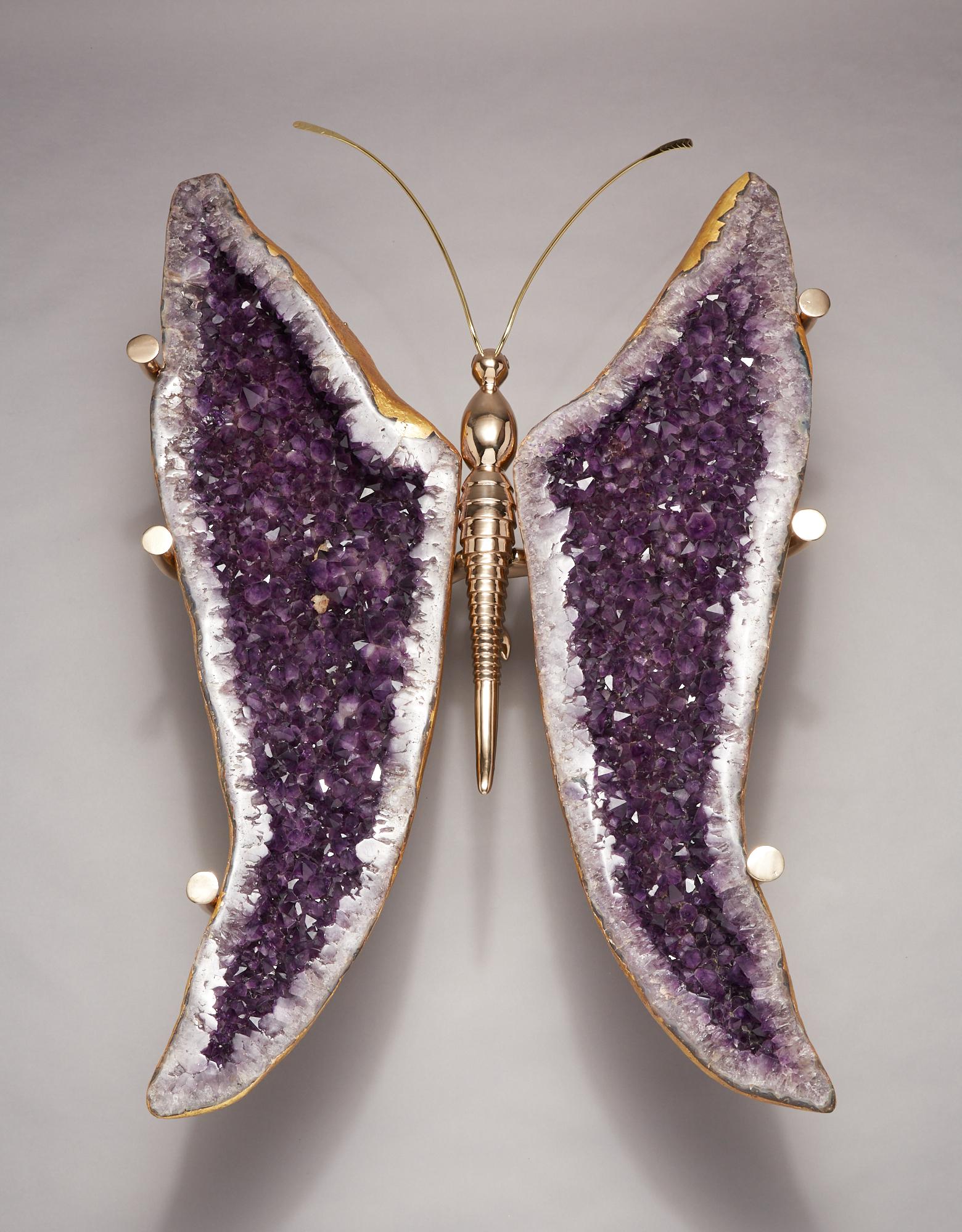 These large naturally wing shaped amethyst geodes are set on a solid cast bronze butterfly body creating one of kind coffee table. Amethyst wings are originally from Brazil and are gilt in 22K gold leaf making this table a functional piece of custom