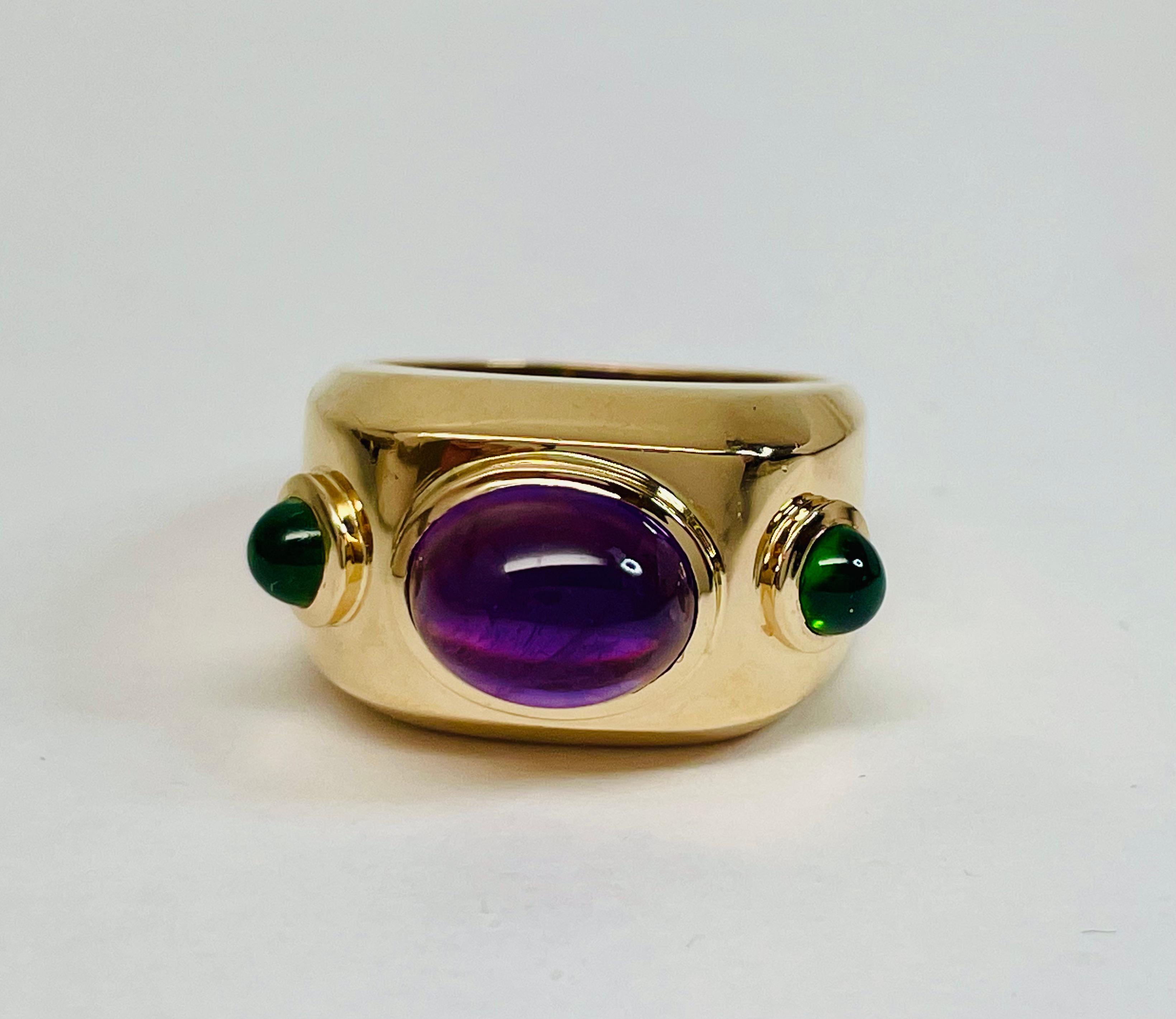 Marcy Feldman for HEARTWEAR DESIGNS created this large heavy dome ring of 14kt. Yellow Gold bezel- set with a 3.5 ct. Cabochon Cut Amethyst. It measures 10 x 8 mm. On each side set in bezels are two bright green  Cabochon Cut Chrome Diopside. These