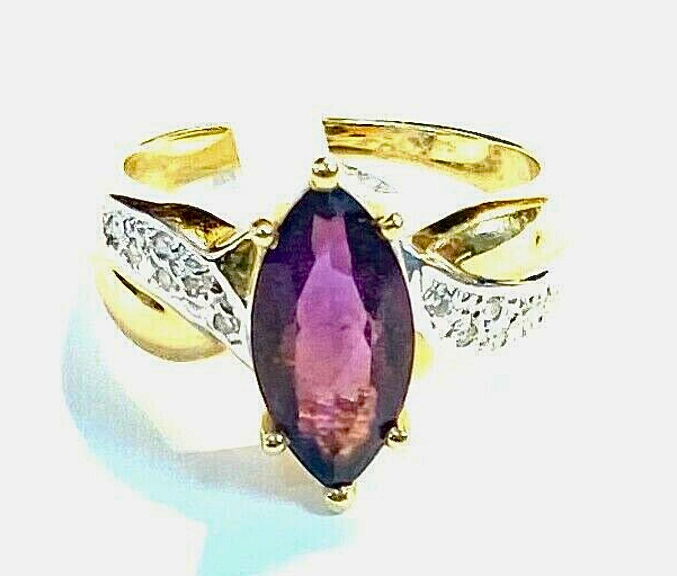 14k yellow gold amethyst and diamond ring, 5.23 Grams TW. The dimensions of the marquise amethyst are approximately 12.6 mm by 7 mm. Approximately 2 carats. Marked 14k.  Approximate size 7.5.